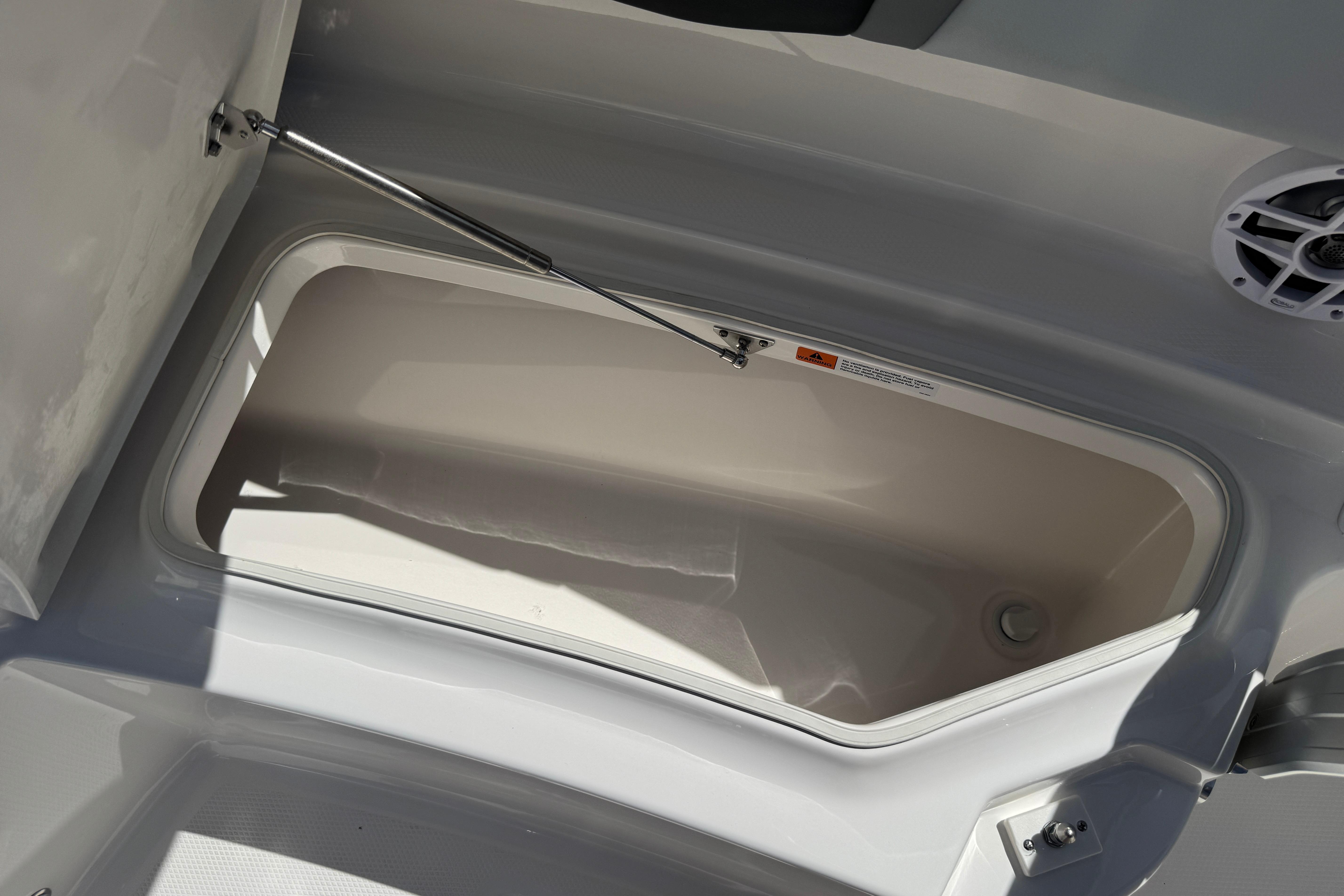 Open storage compartment on 2026 Robalo R250 Center Console boat.