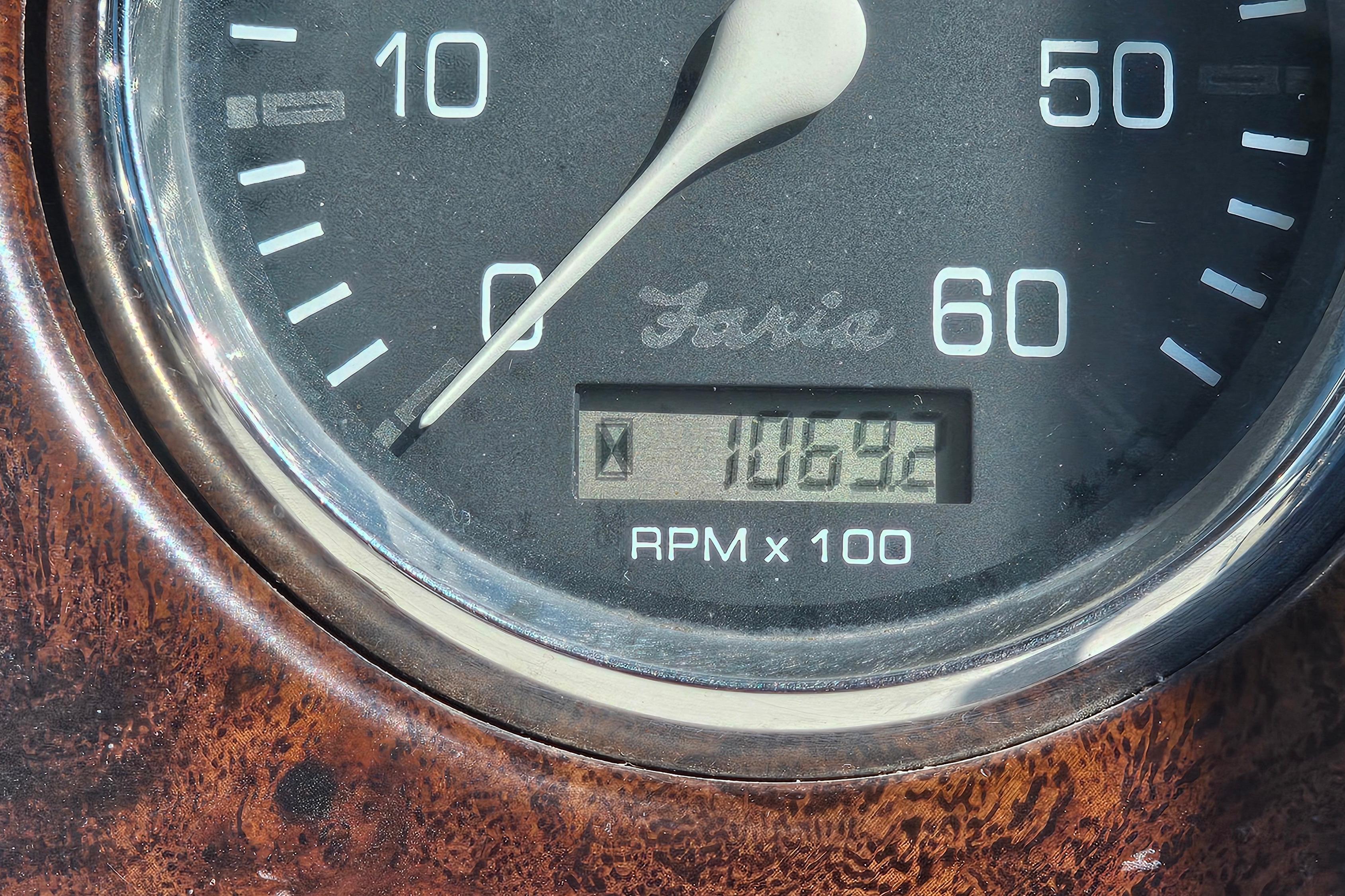 Close-up of Crownline 242 CR 2000 tachometer showing 1069.2 RPM x 100.