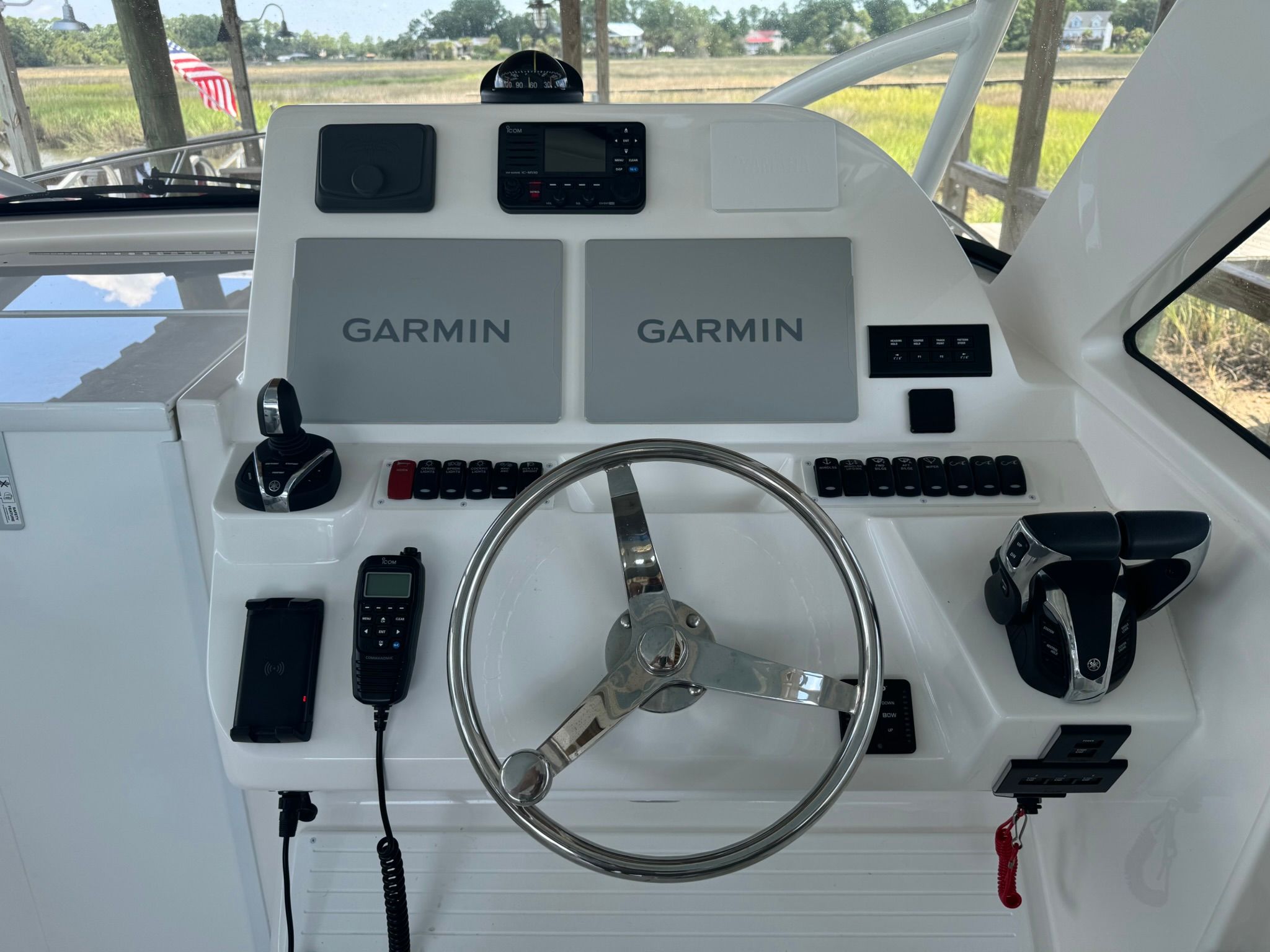The image shows the helm of a 2024 Albemarle 30 Express boat with Garmin devices.