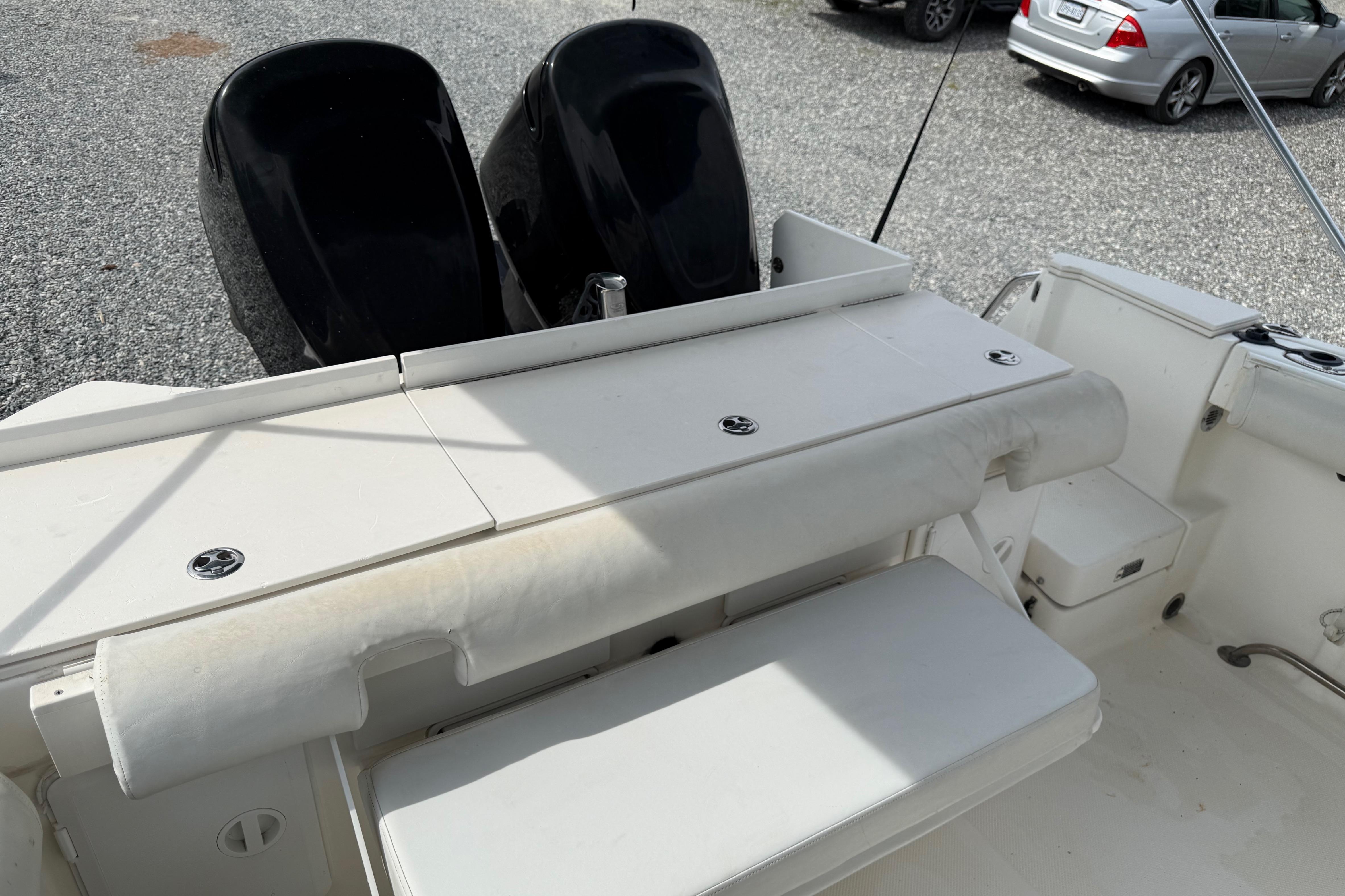 2006 Trophy 2502 Walkaround boat interior with seating and dual outboard motors.
