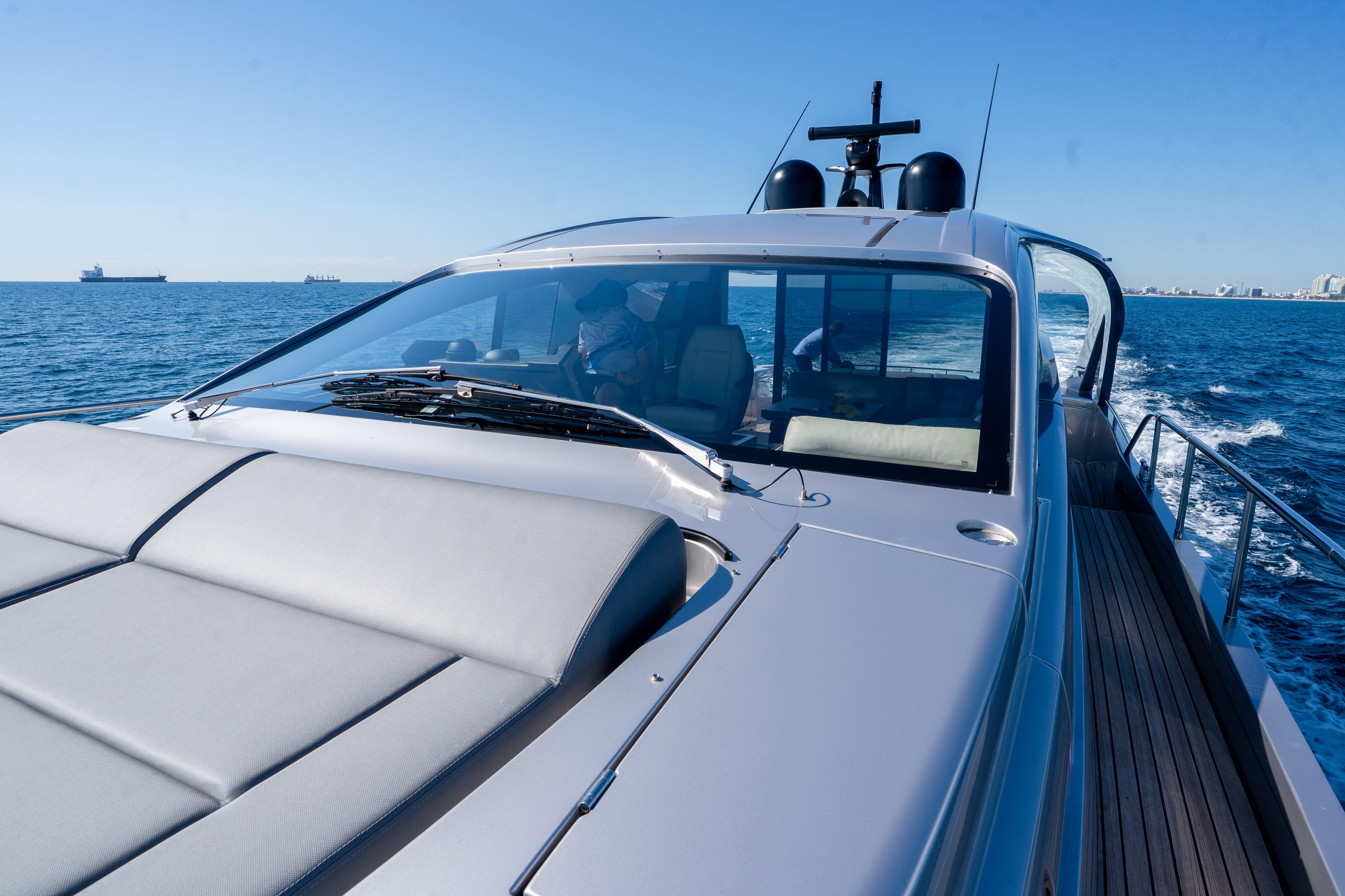 2024 Pershing 7X yacht cruising on open sea under clear blue sky.