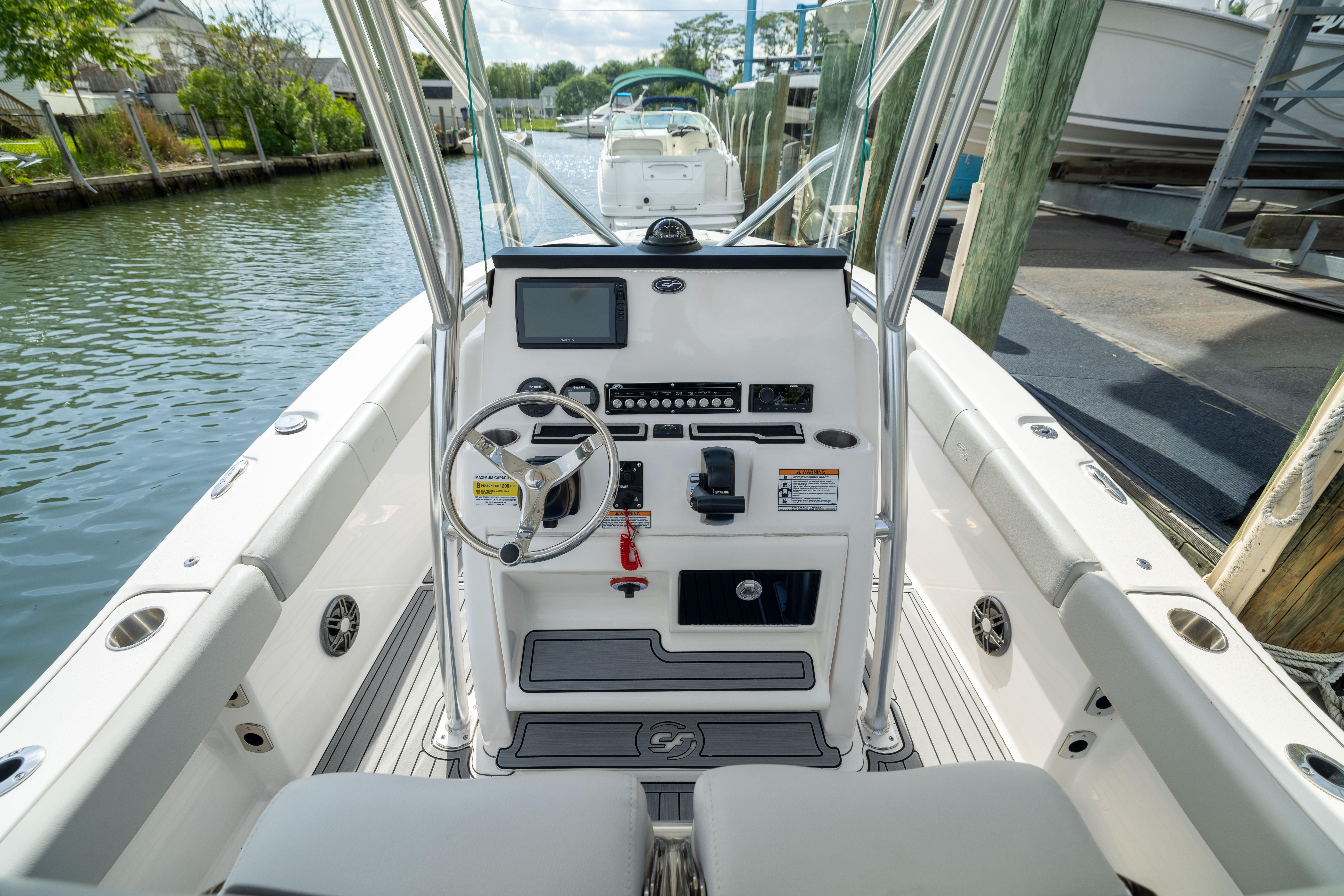 2023 Sea Fox 228 Commander boat cockpit with steering wheel and control panel.