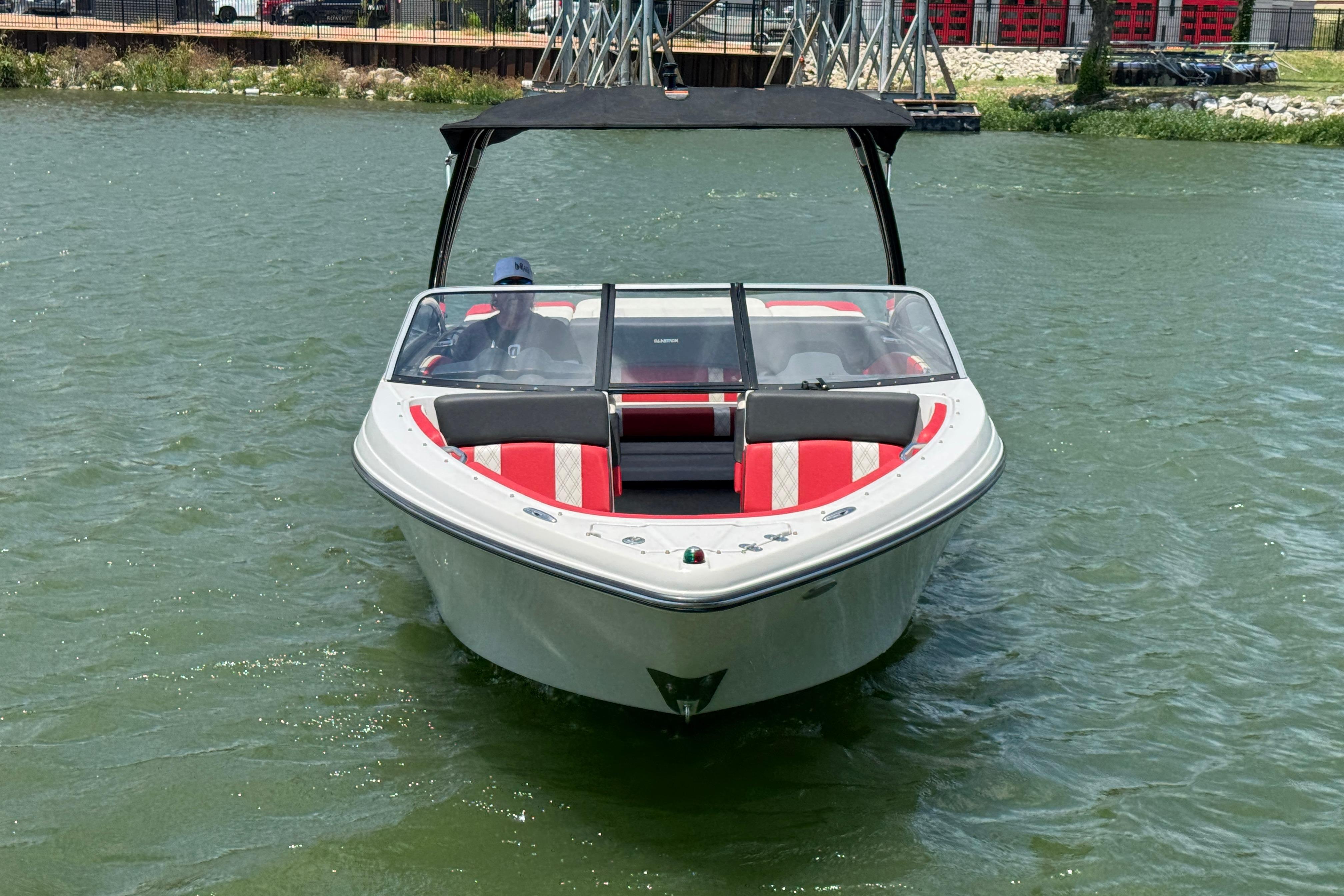 2017 Glastron GT 225 boat on water with red and white seating.