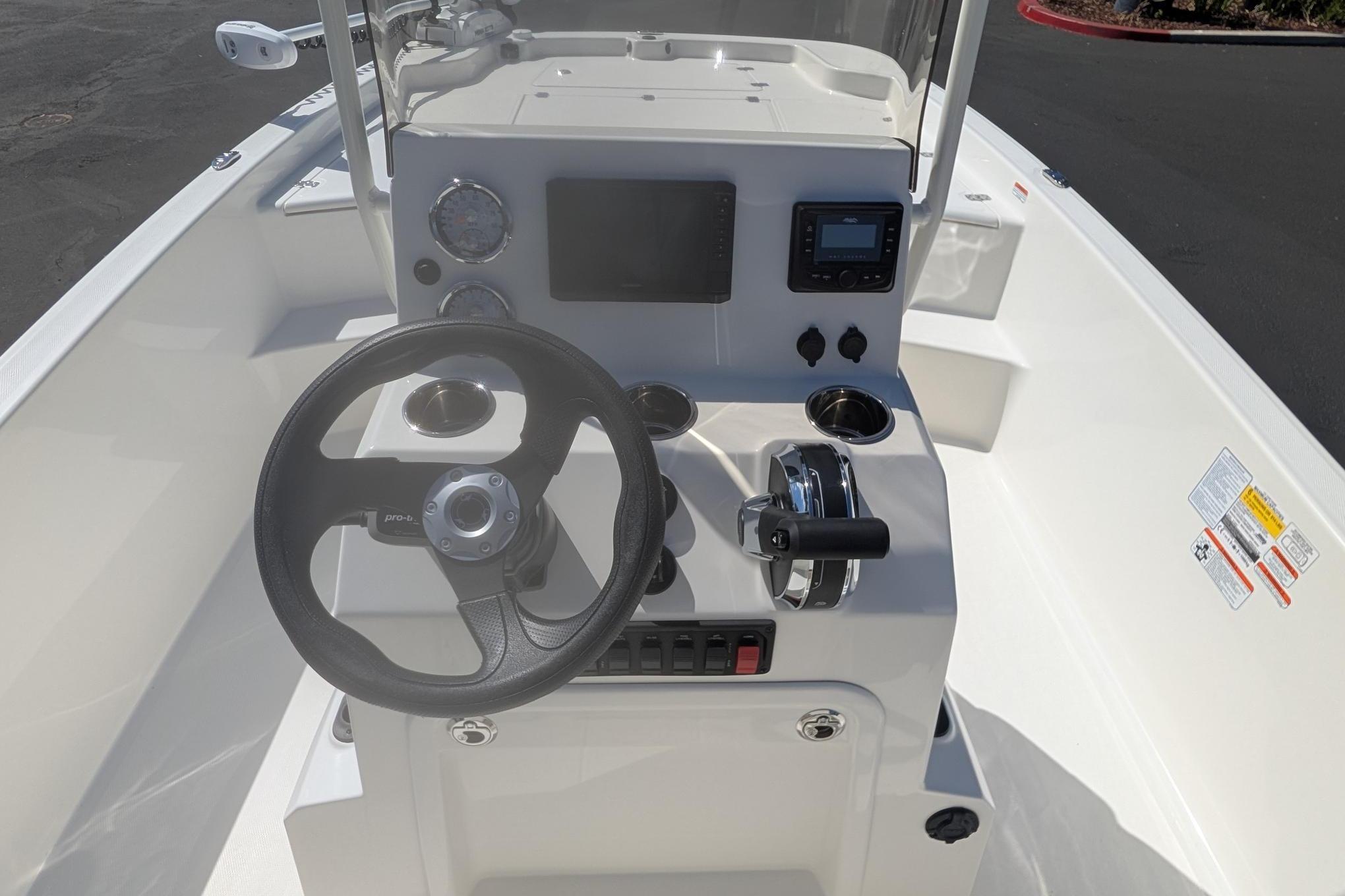 2026 Mako Pro Skiff 19 CC boat console with steering wheel and controls.