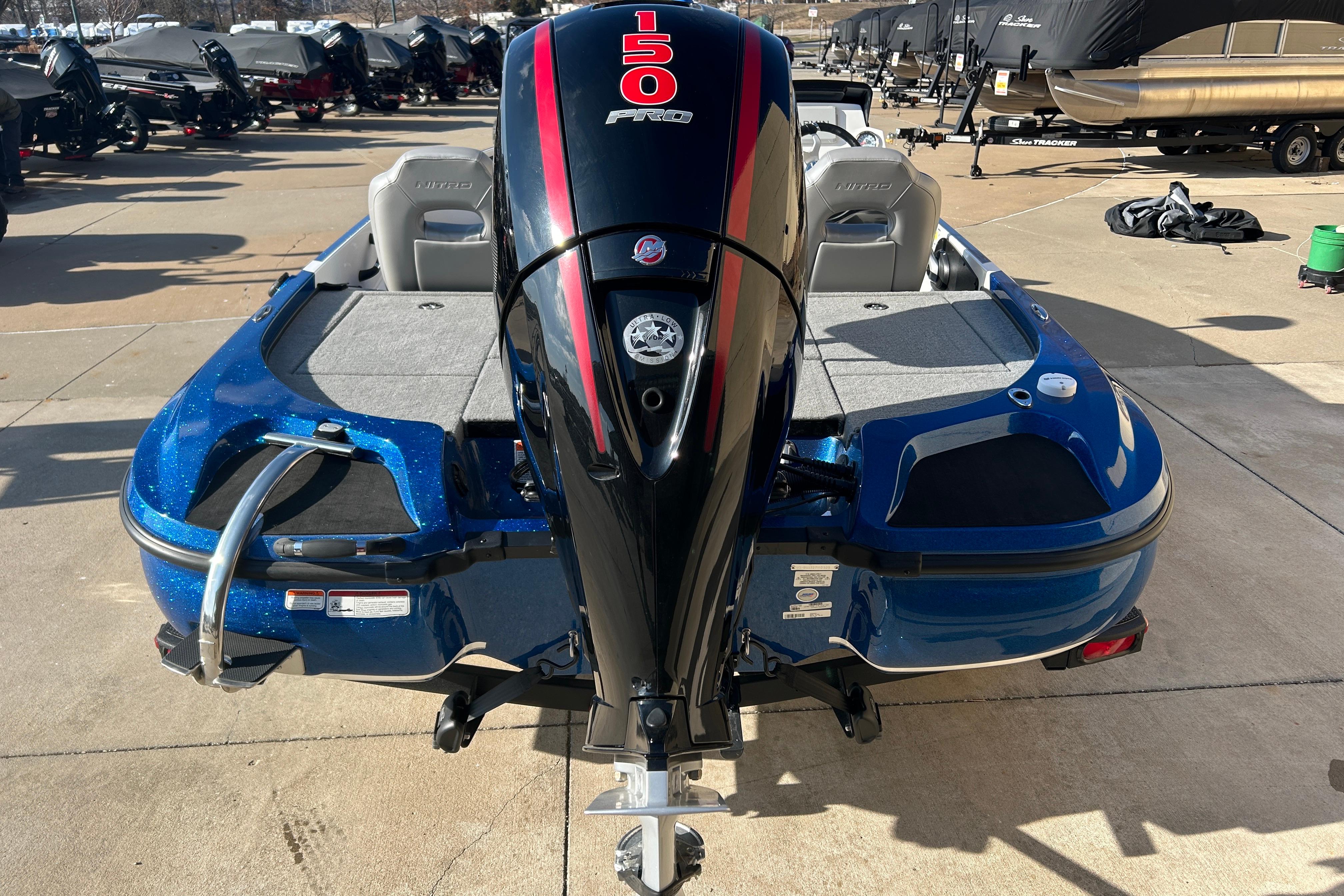 2025 Nitro Z18 Pro boat with powerful outboard motor, parked on concrete surface.