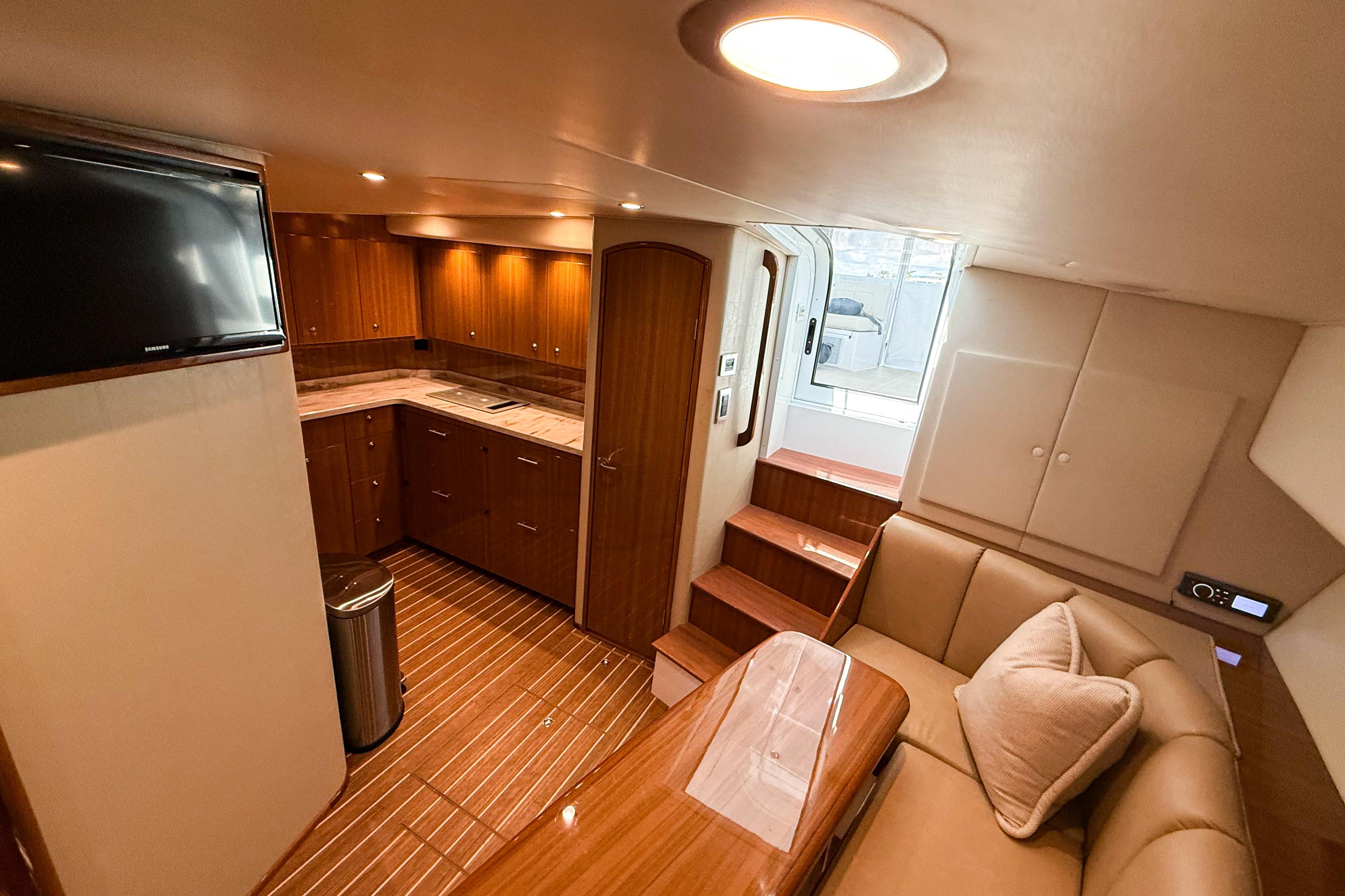 Luxurious interior of 2021 Viking 44 Open yacht with modern kitchen and seating area.
