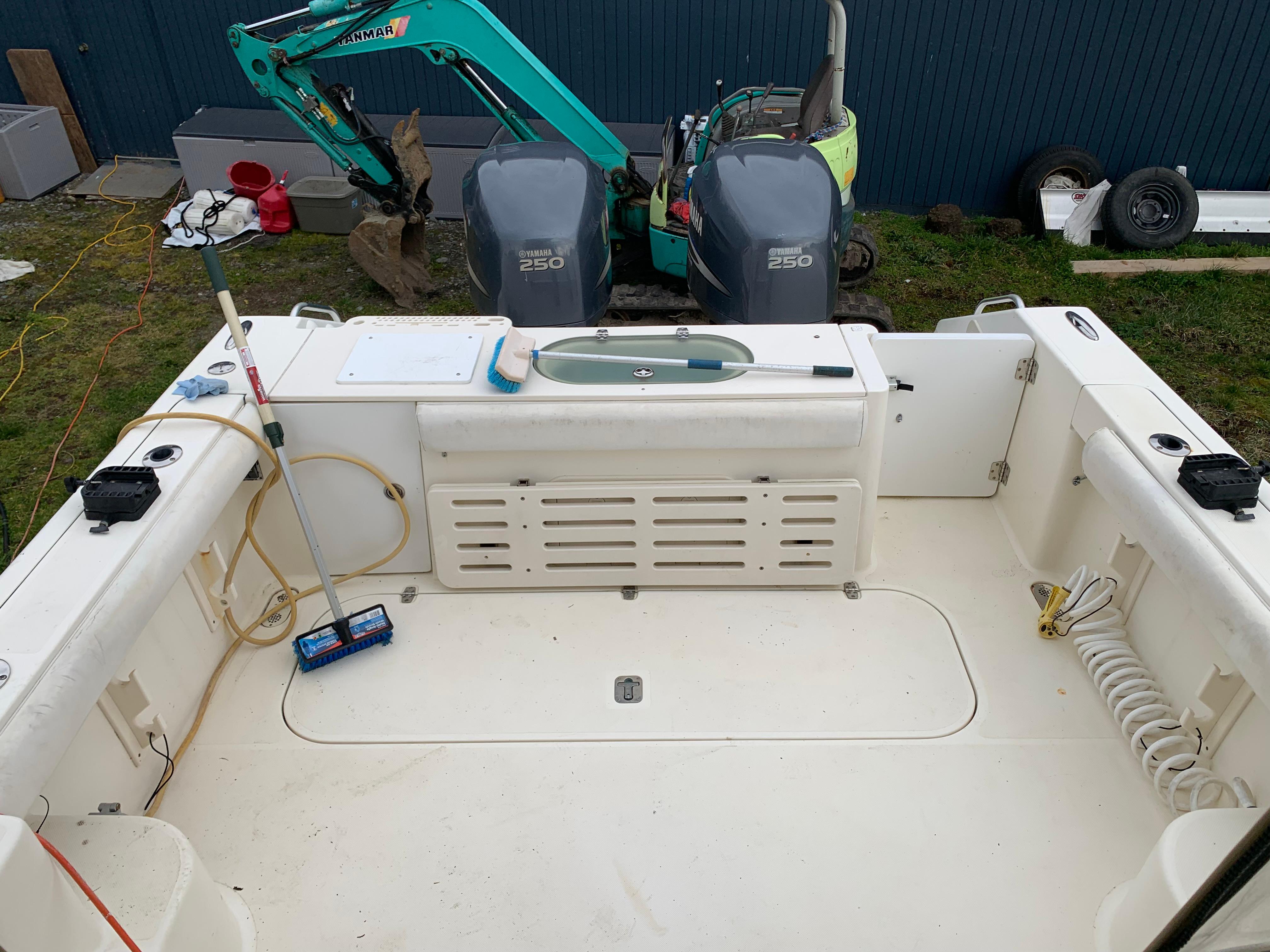 2007 Pursuit OS 335 boat deck with twin engines and fishing equipment.