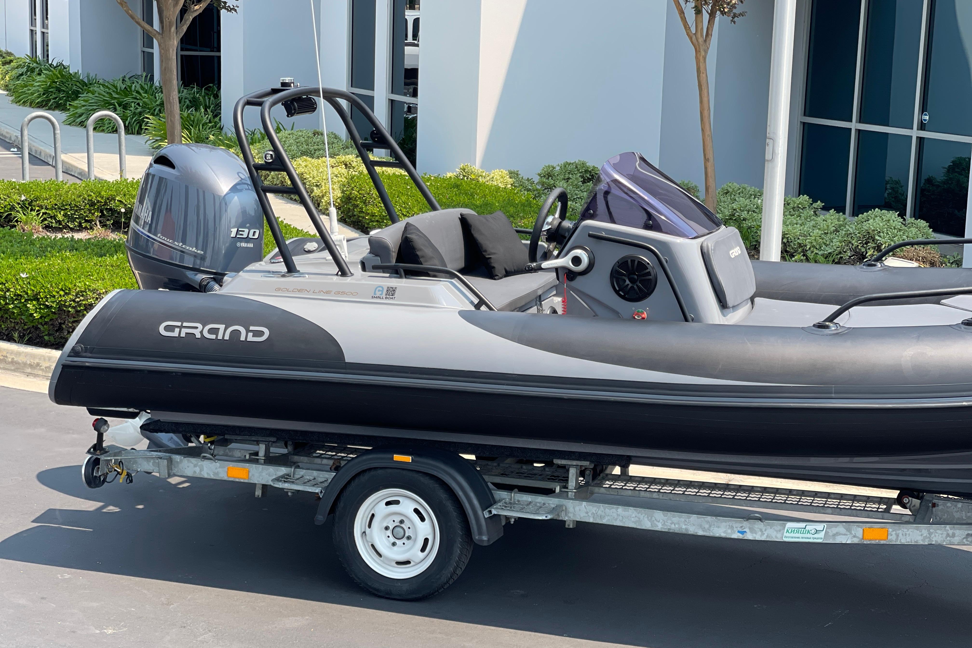 2017 Grand Goldenline 500 boat on trailer, parked outdoors with Yamaha 130 engine.