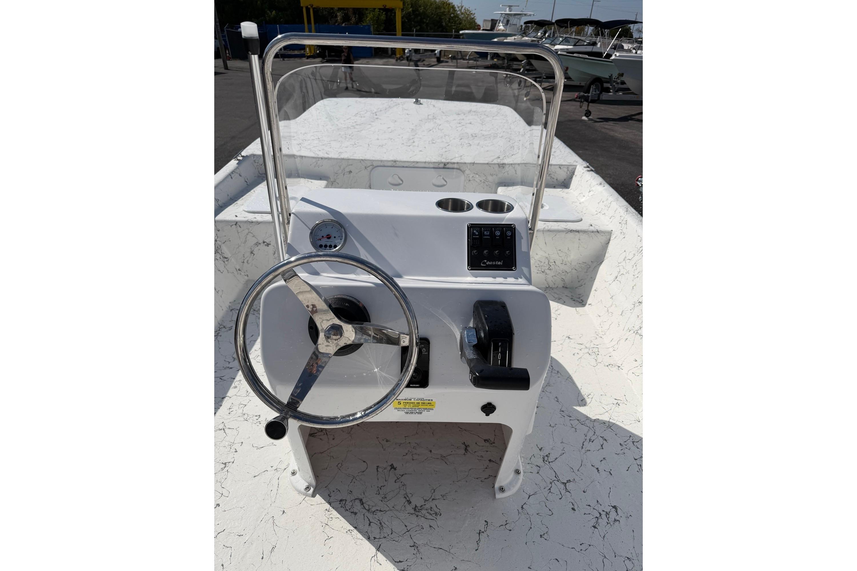 2027 Coastal Skiff 184 boat console with steering wheel and controls.