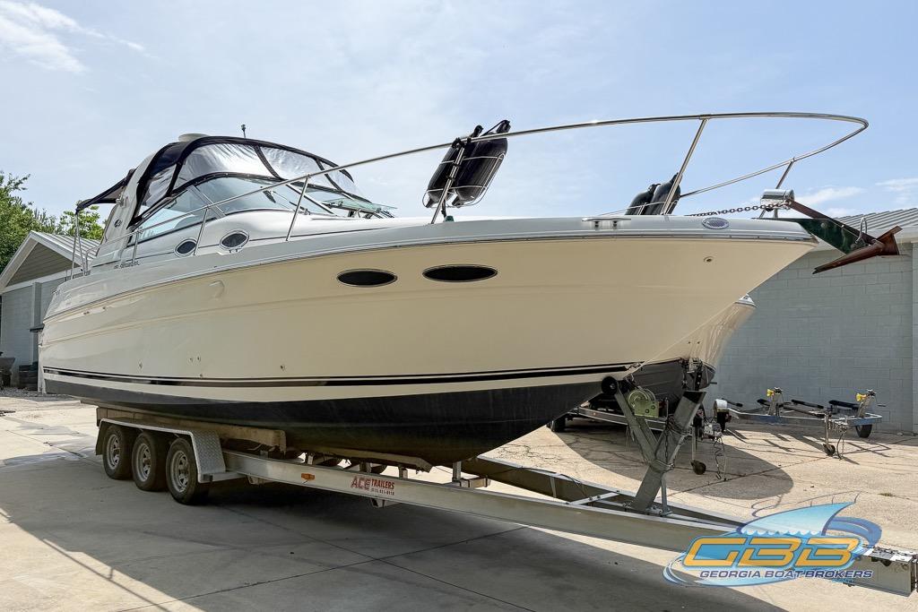 1999 Sea Ray 290 Sundancer boat on trailer, displayed outdoors at Georgia Boat Brokers.