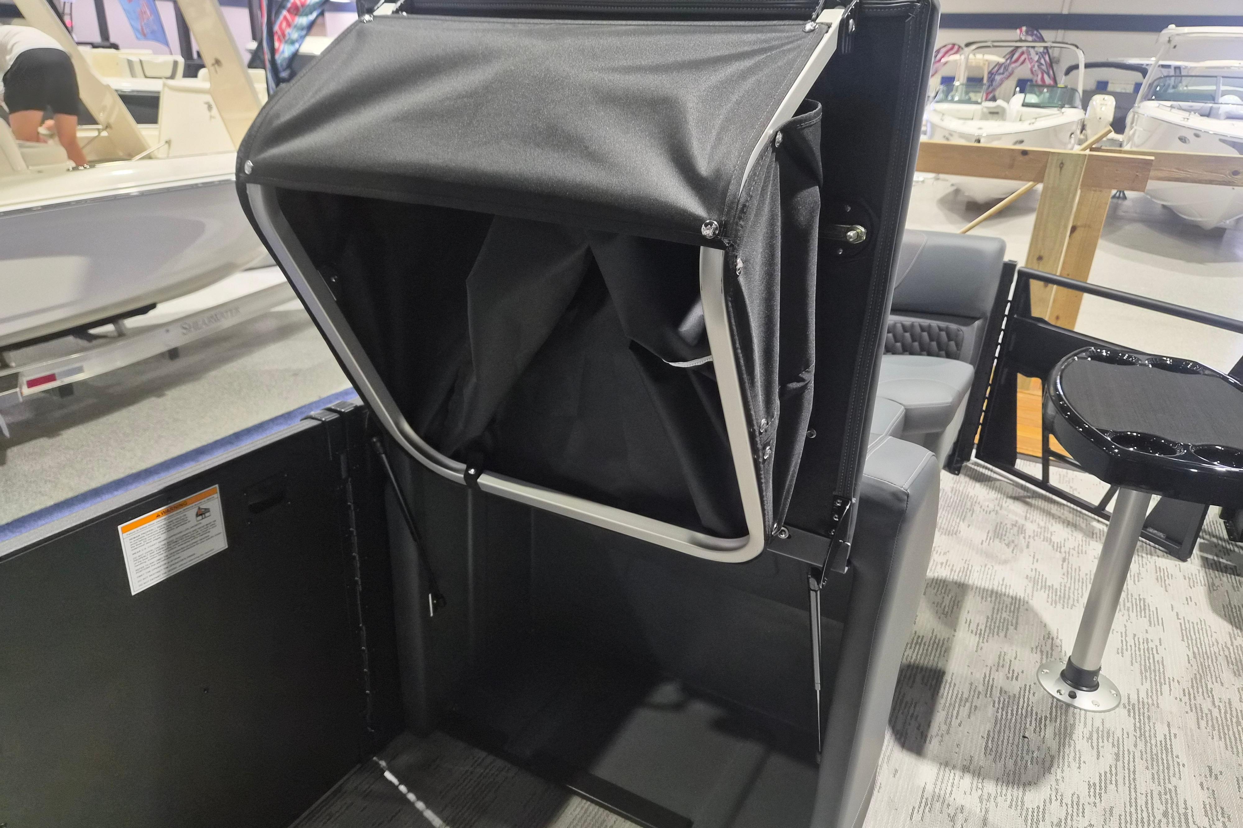2026 Sylvan L3 ULZ boat interior with foldable storage compartment and seating area.