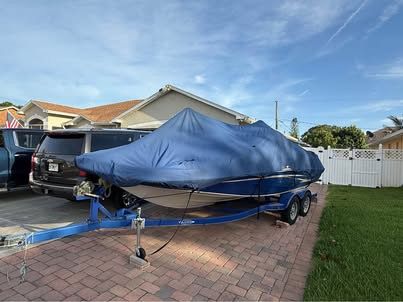2011 Tahoe 216 WT boat covered on trailer.