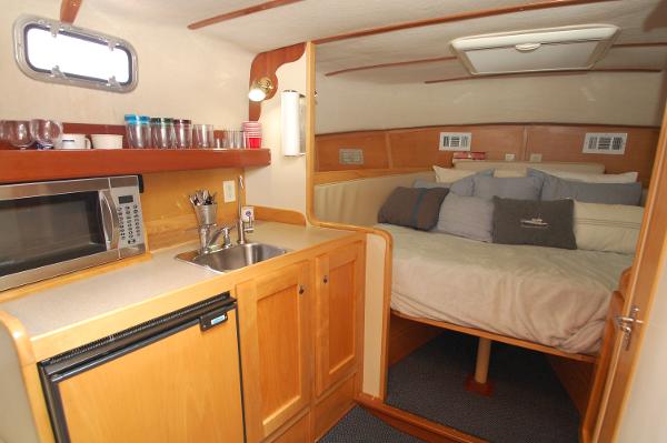 Interior of a 2005 Fox Island Thirty - Sedan Cruiser with kitchenette and sleeping area.