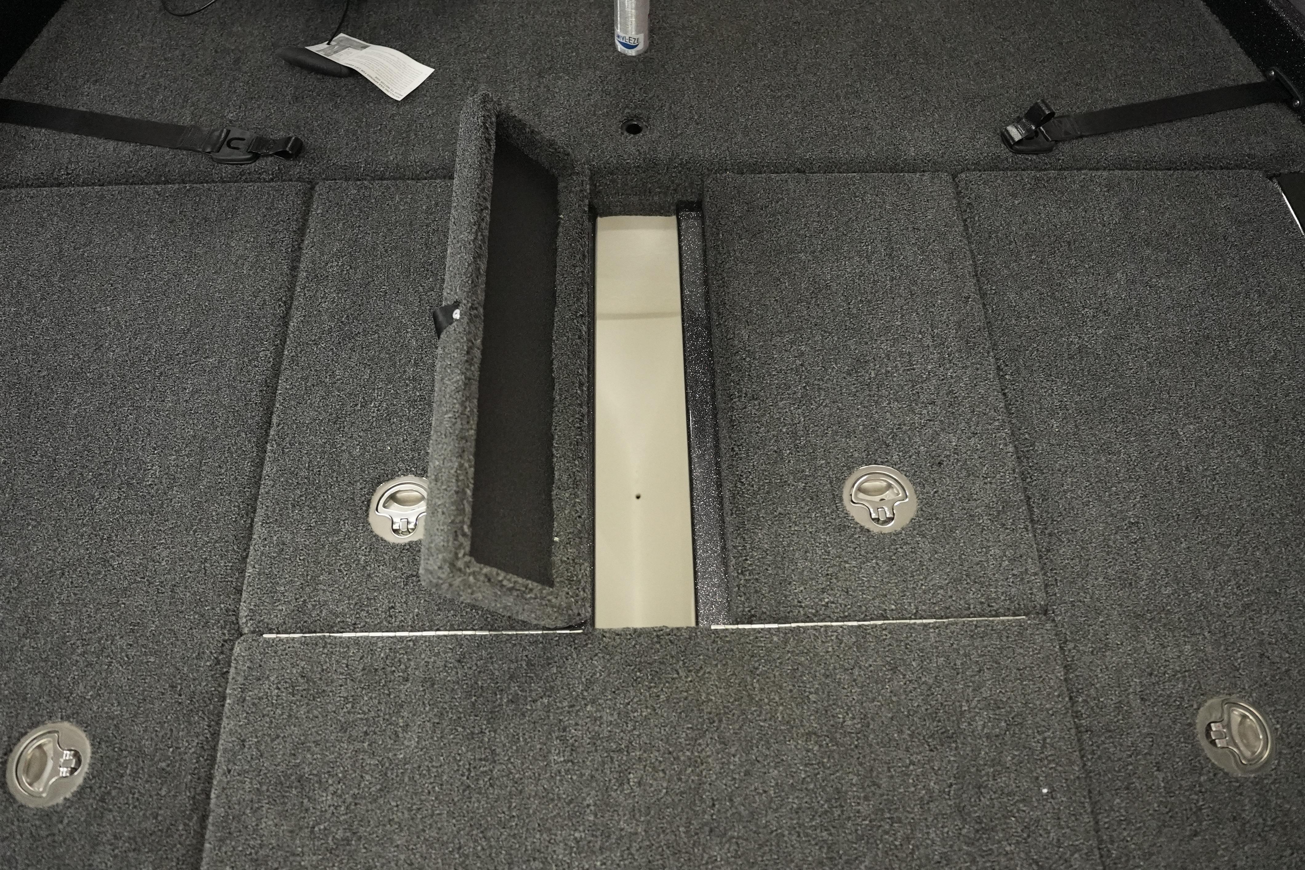 2026 Bass Cat Puma STS boat storage compartment with open hatch and carpeted interior.