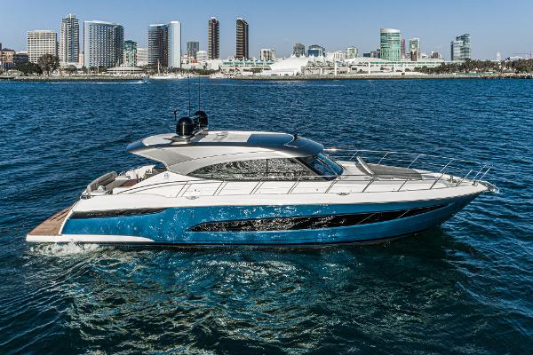 2021 Riviera 5400 Sport Yacht cruising near a city skyline.