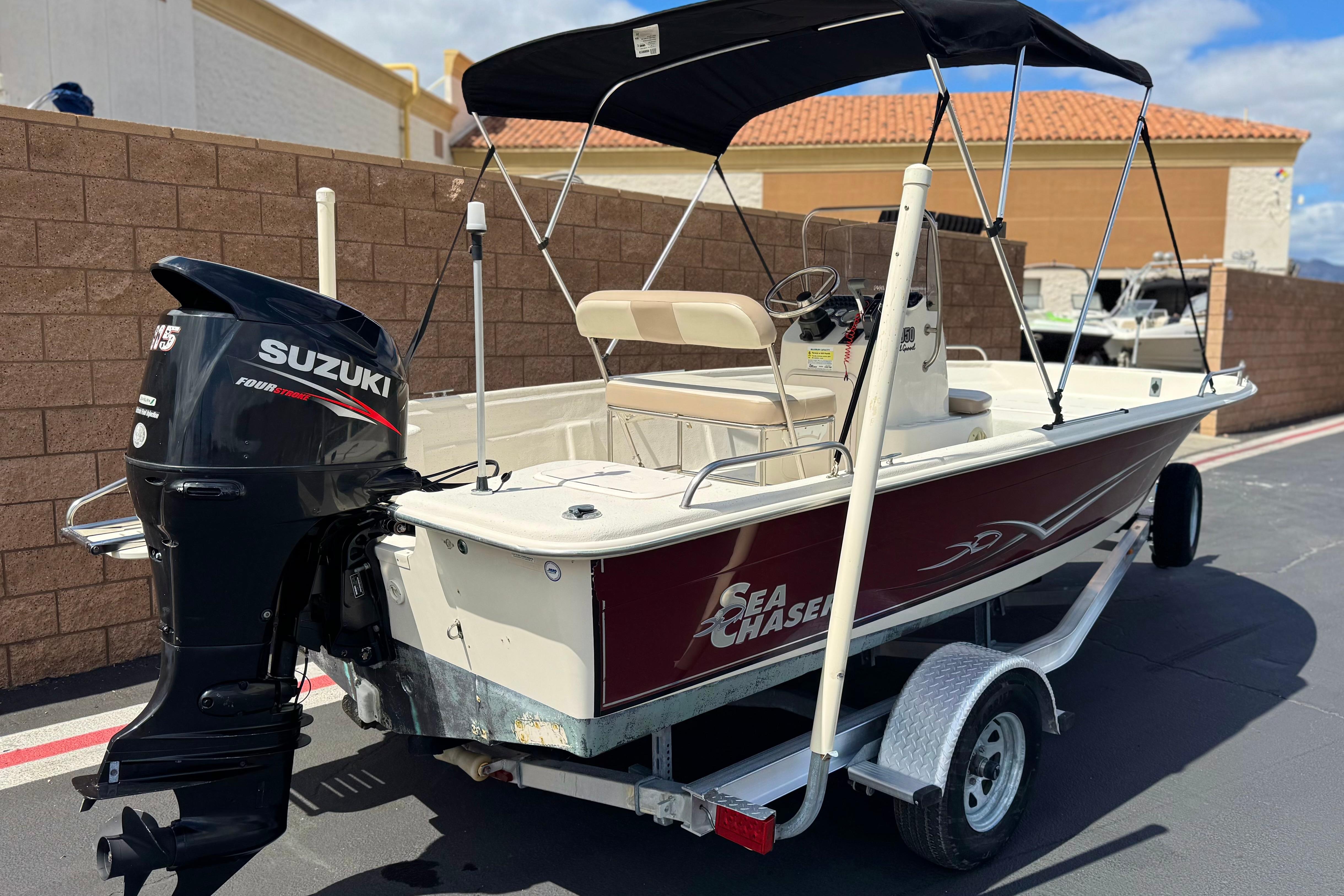 2013 Carolina Skiff Sea Chaser 1950 RG boat with Suzuki outboard motor on trailer.