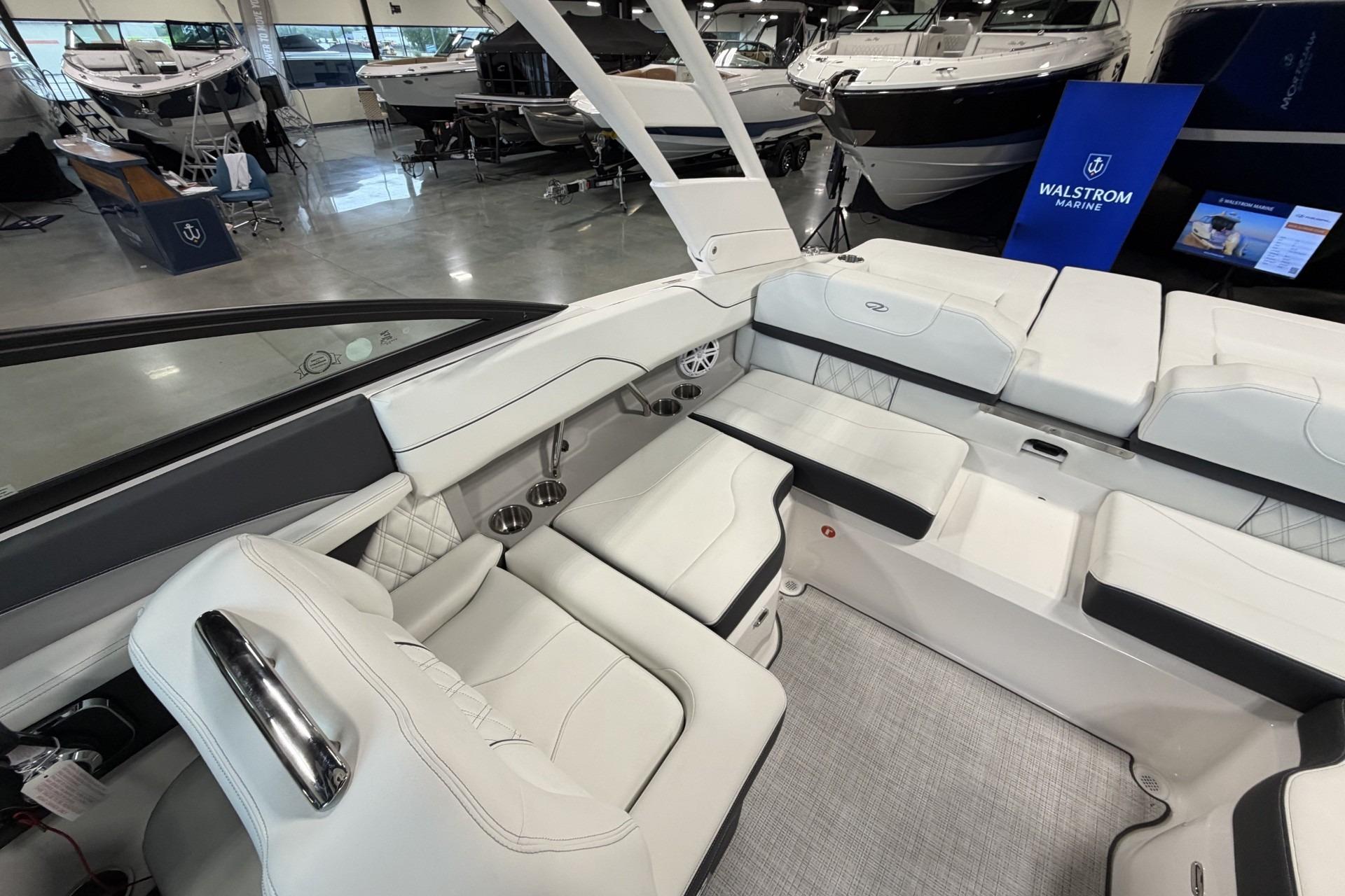 Luxurious interior of 2027 Regal LS2 boat with white seating in showroom.