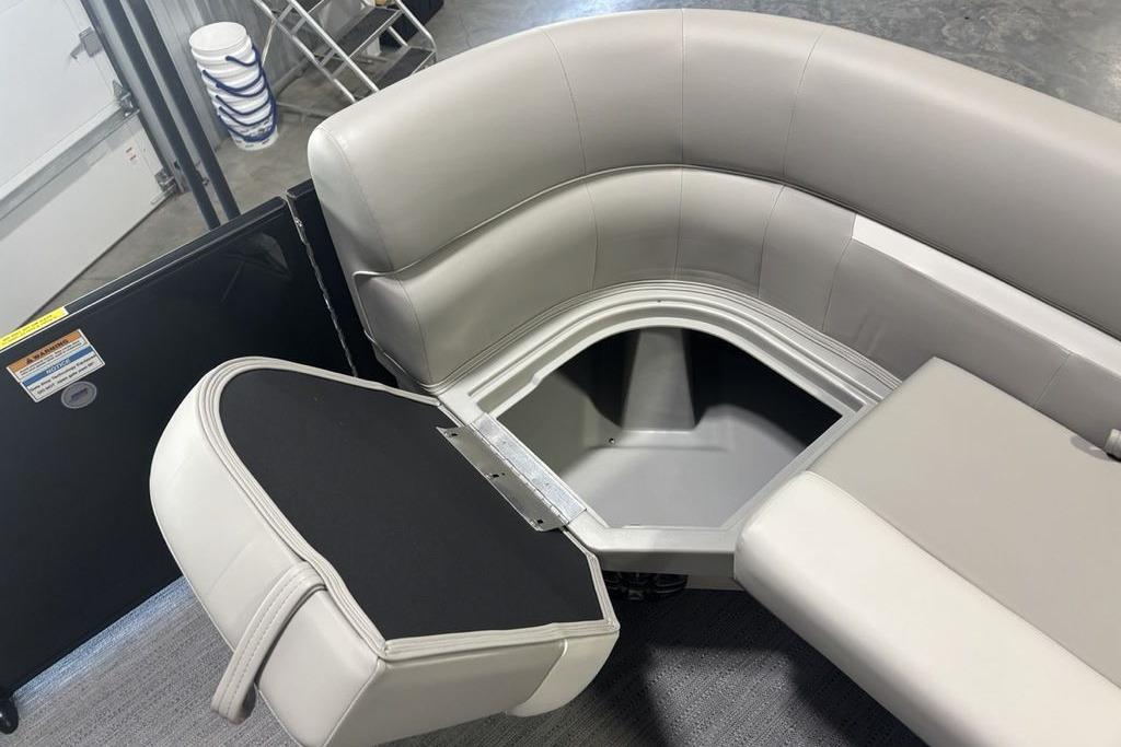 Interior view of 2026 Godfrey Xperience 2086 SFLX boat with open storage compartment.