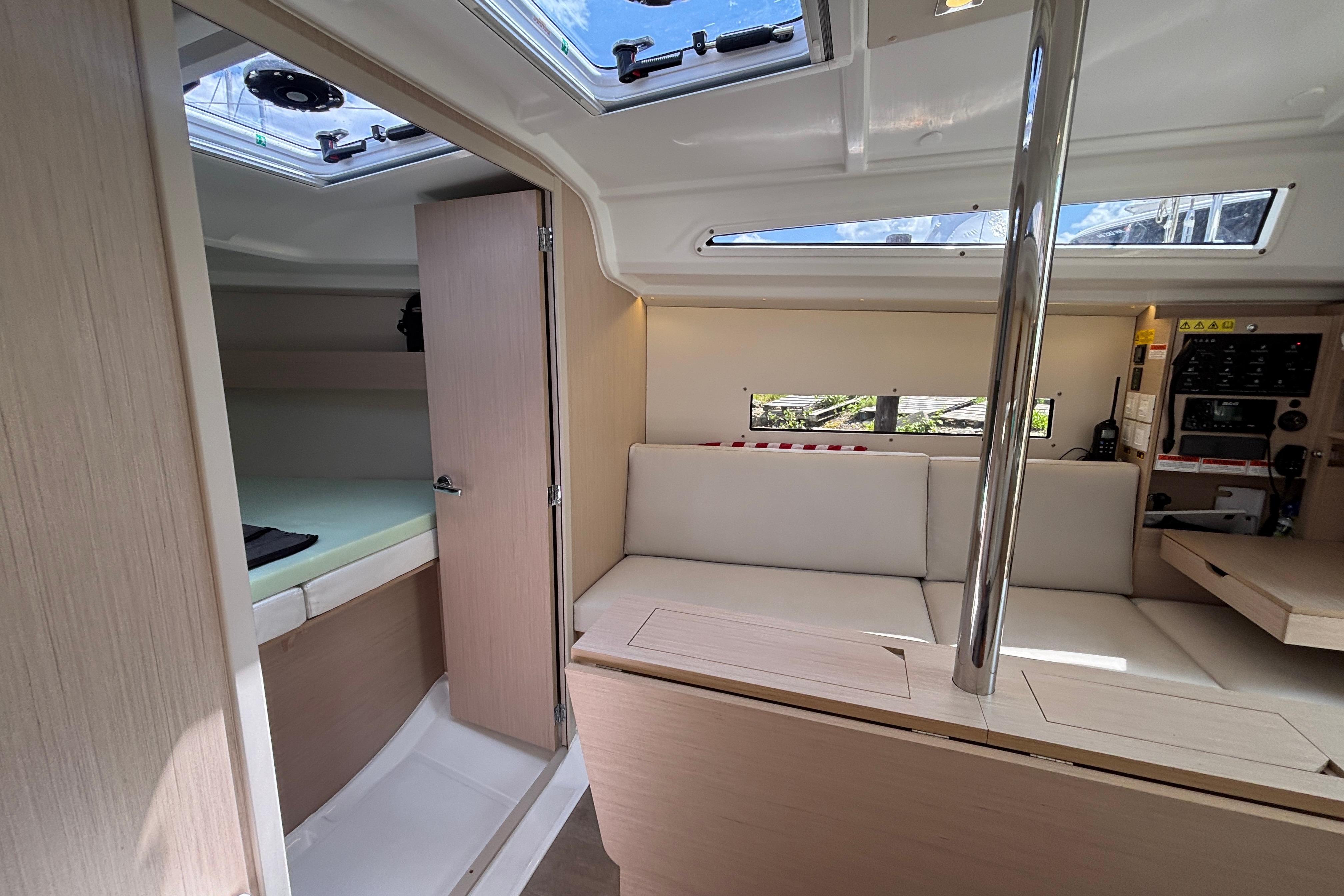 Interior of 2021 Beneteau Oceanis 30.1 yacht, featuring modern seating and navigation area.