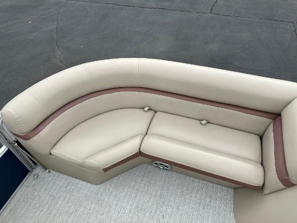 The image shows a beige and brown seating area on a boat.