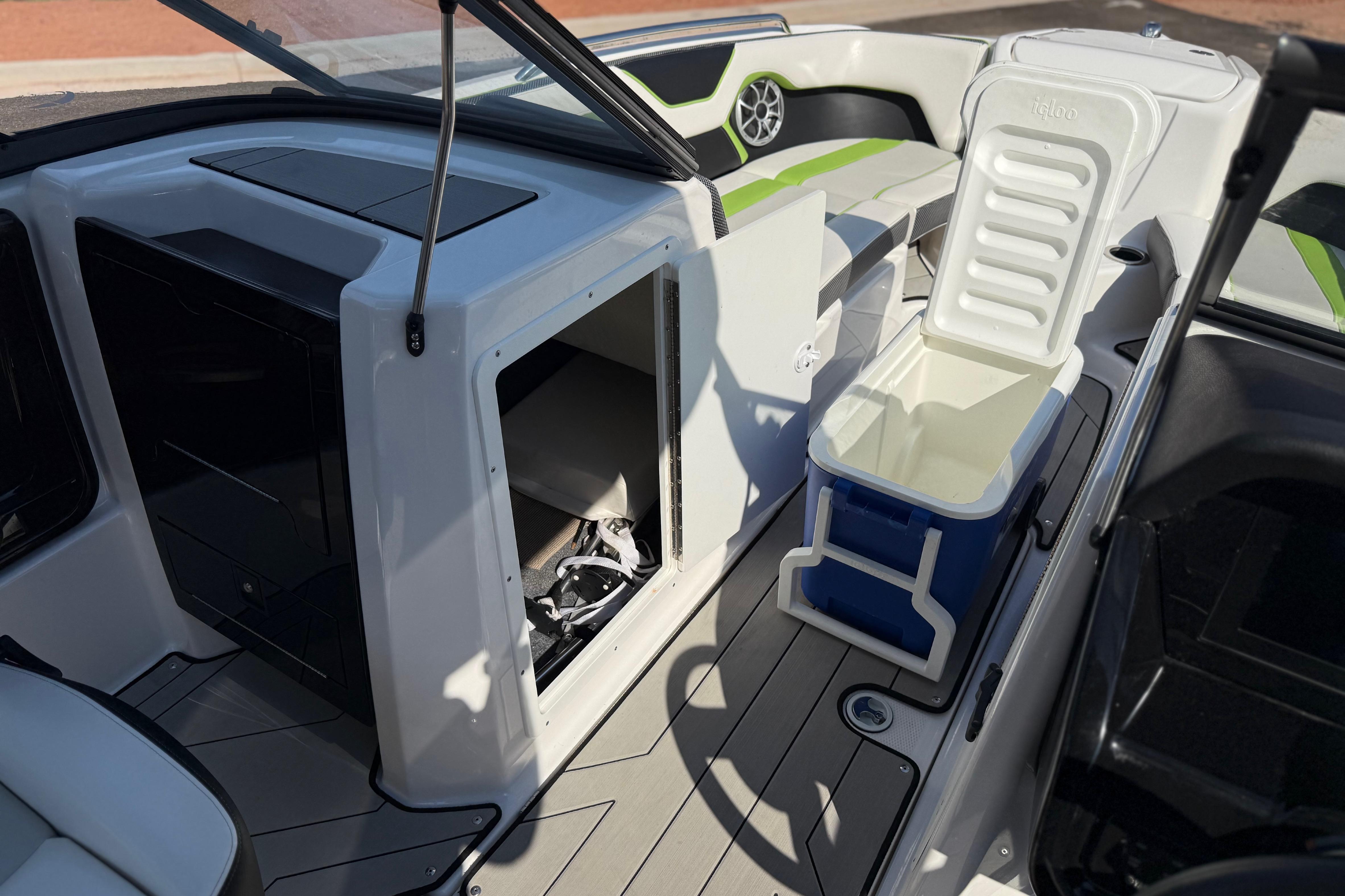 2022 Yamaha Boats 212XE interior with open storage and cooler on deck.