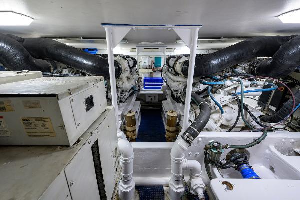 Engine room of 2000 Viking 50 Convertible yacht, showcasing machinery and piping systems.
