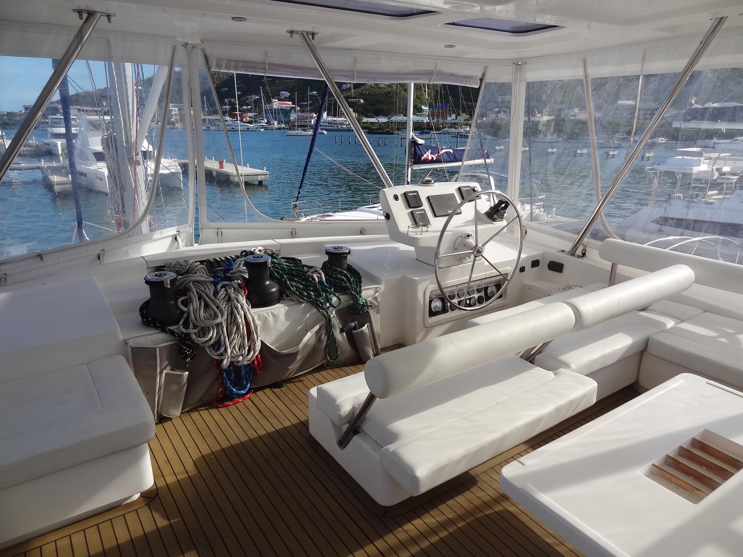 Leopard 58 yacht cockpit, 2014 model, with helm station and marina view.