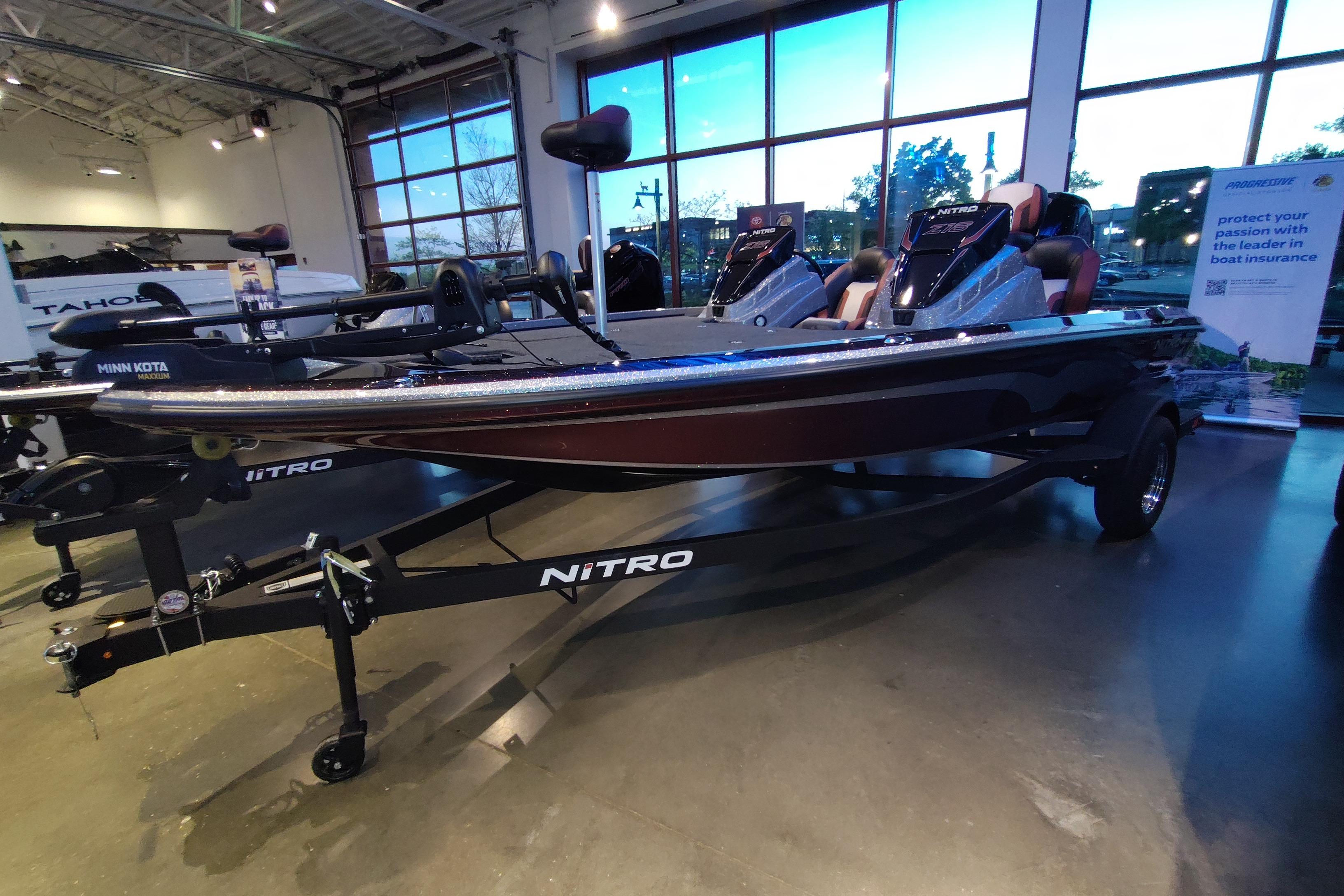 2026 Nitro Z18 boat displayed indoors with Minn Kota motor and sleek design.