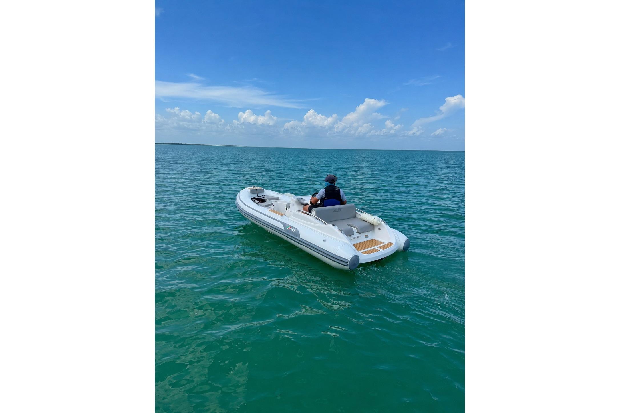2022 AB Inflatables ABJET 430XP on calm ocean waters under a clear blue sky.