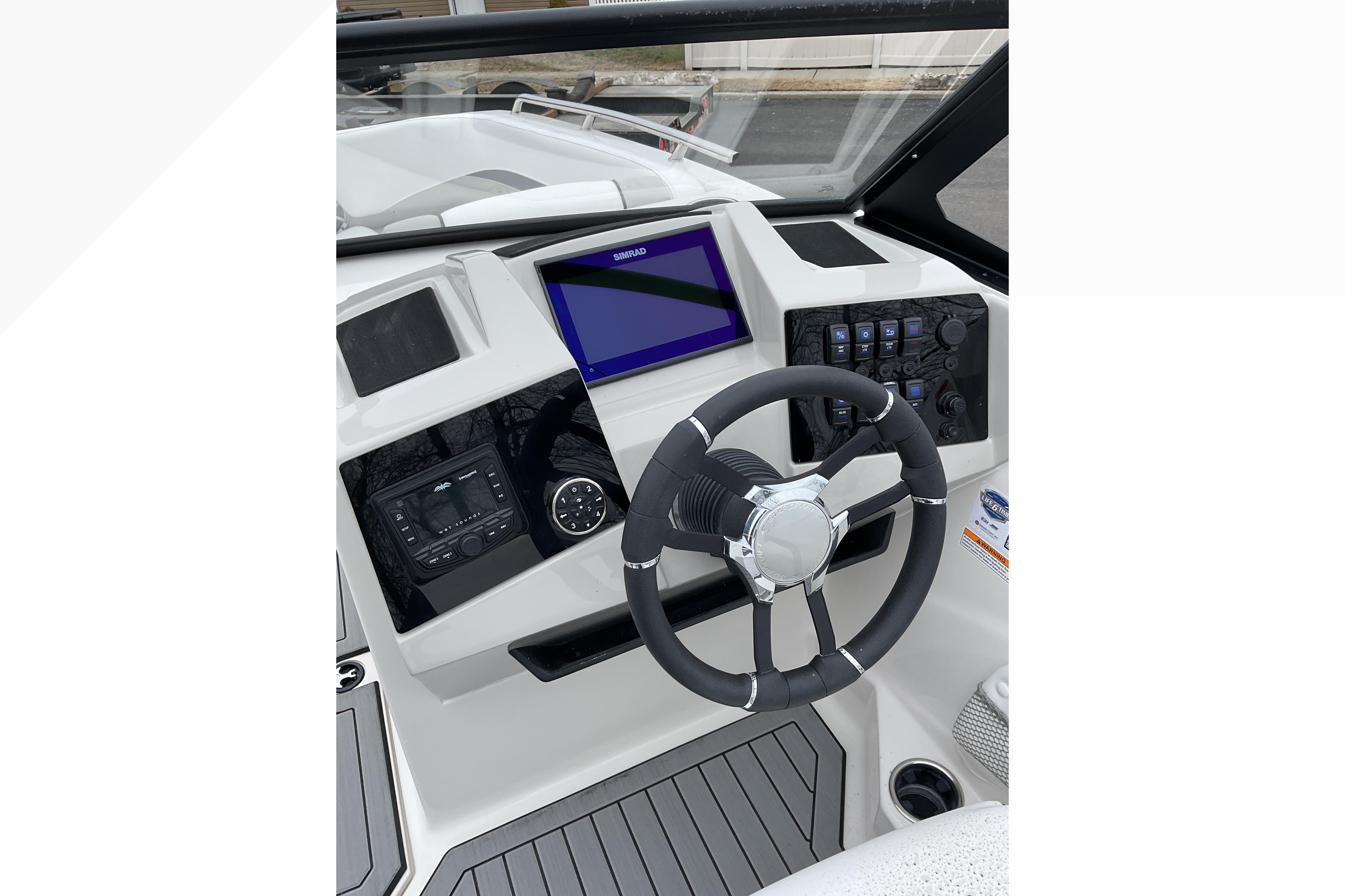 2026 Starcraft SVX 210 DC OB boat dashboard with steering wheel and digital display.