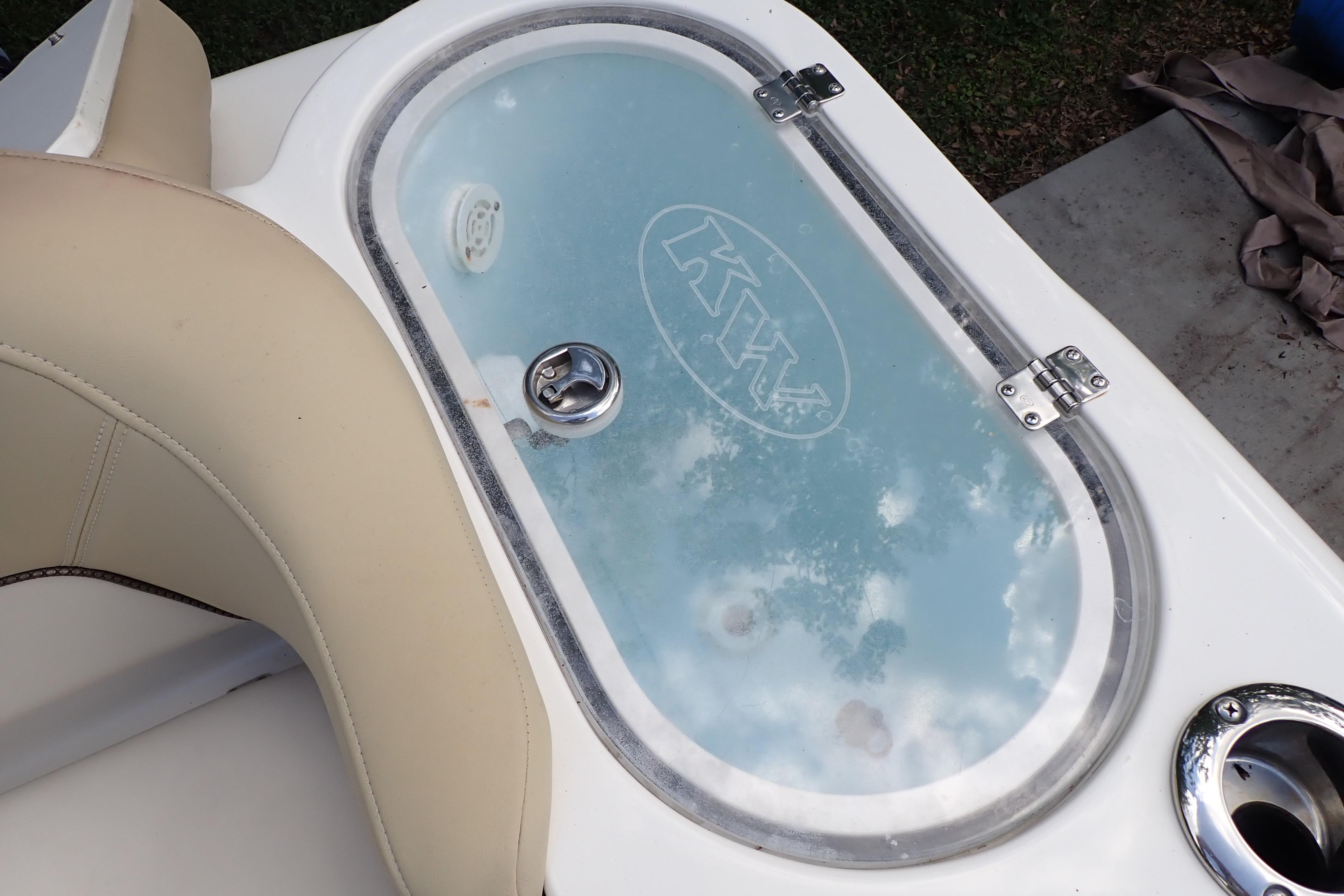 Livewell on 2019 Key West 263 FS boat with clear lid and beige seating.