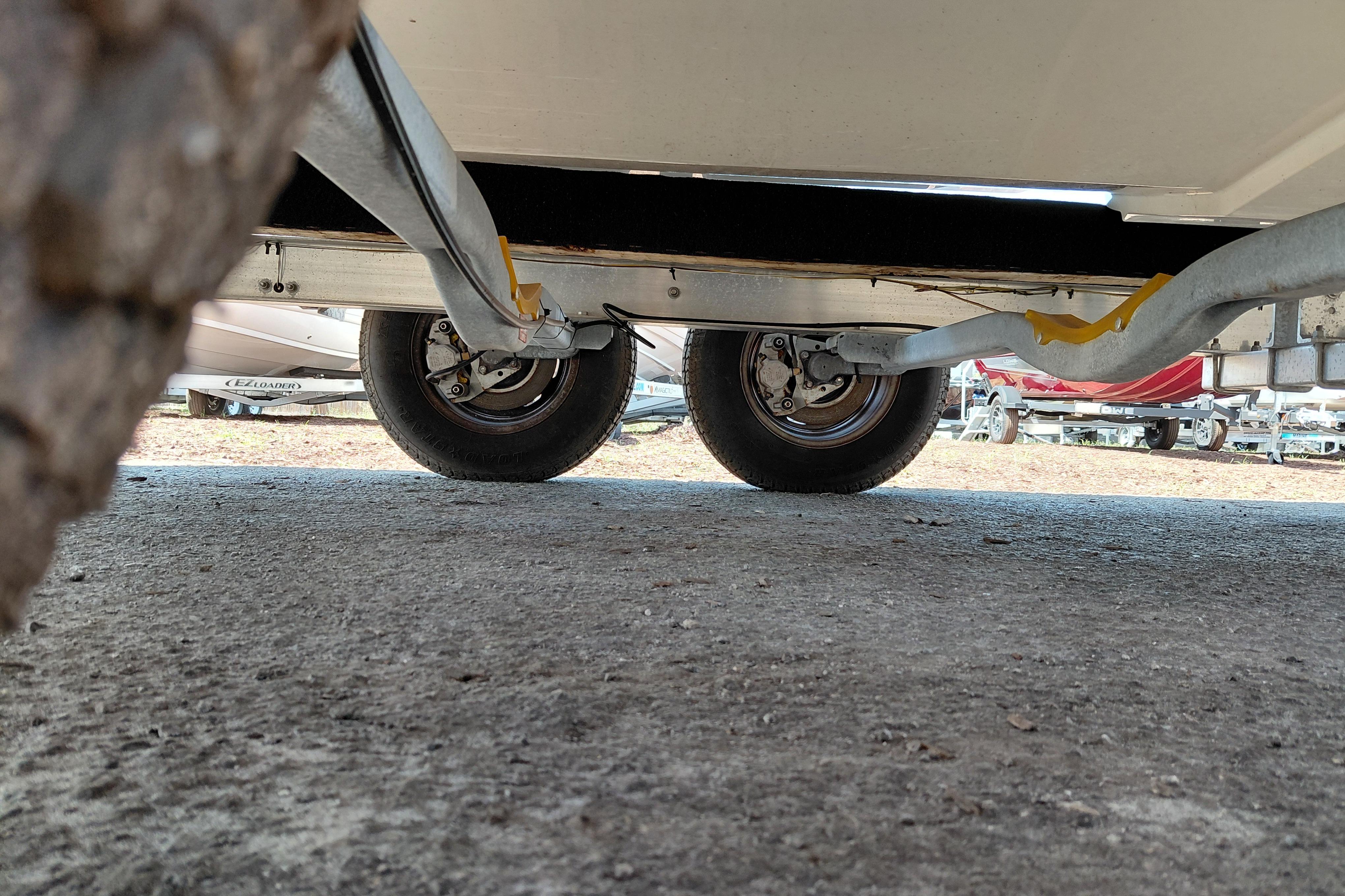 Underneath view of a 2022 Pathfinder 2300 HPS trailer with visible wheels and suspension.
