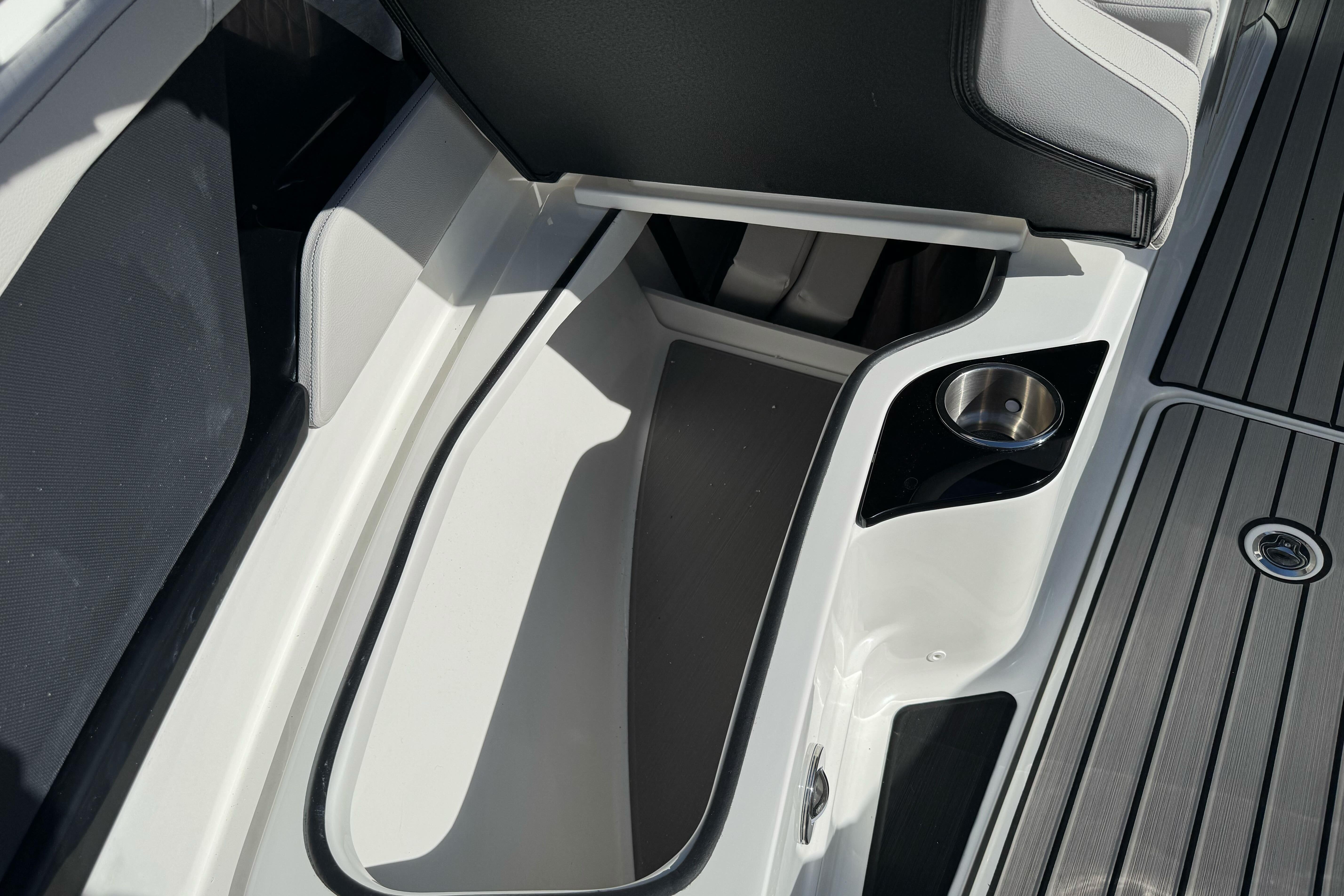 2026 Sea Ray SLX 260 boat interior storage compartment with cup holder.