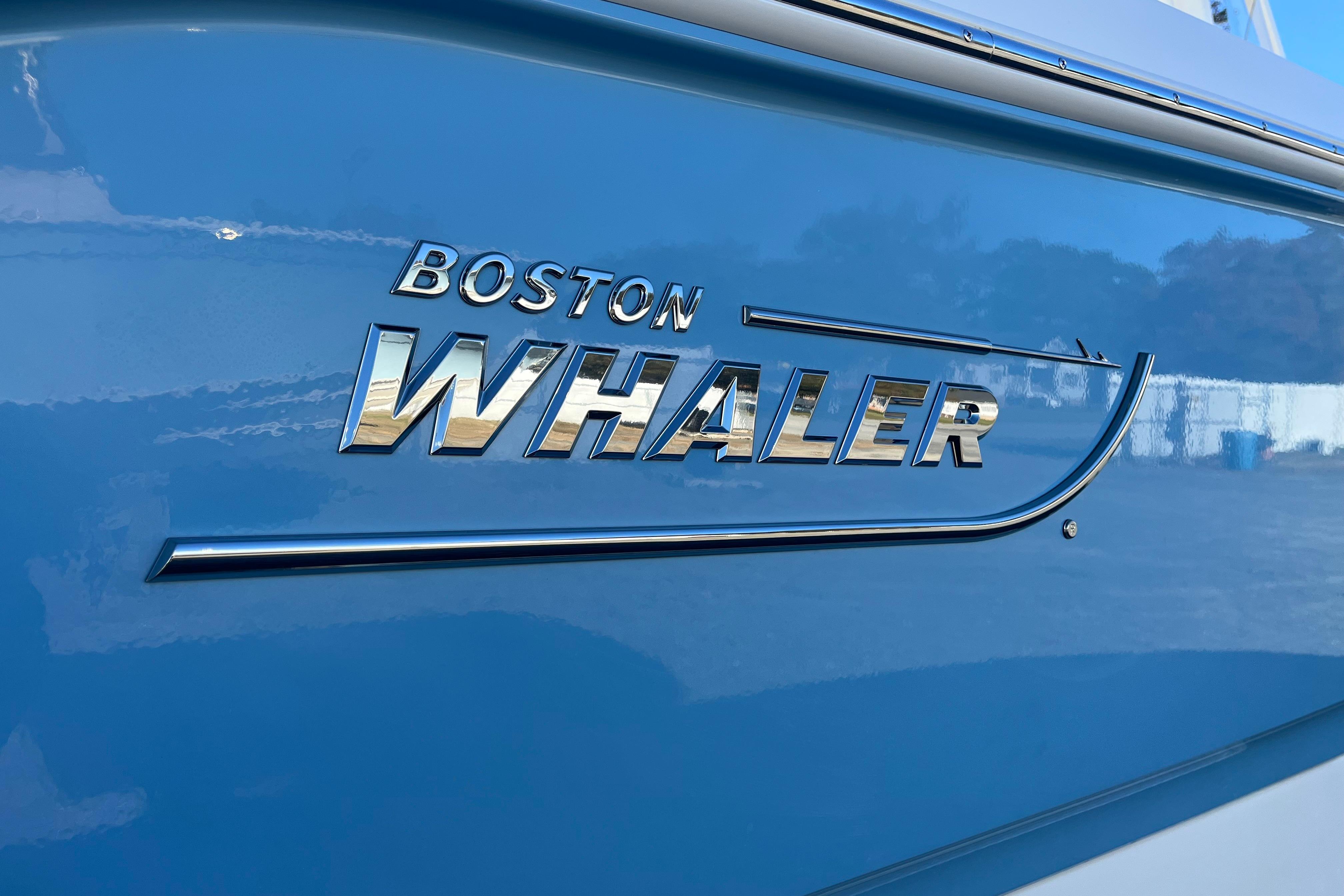 2026 Boston Whaler 280 Dauntless logo on blue boat hull.