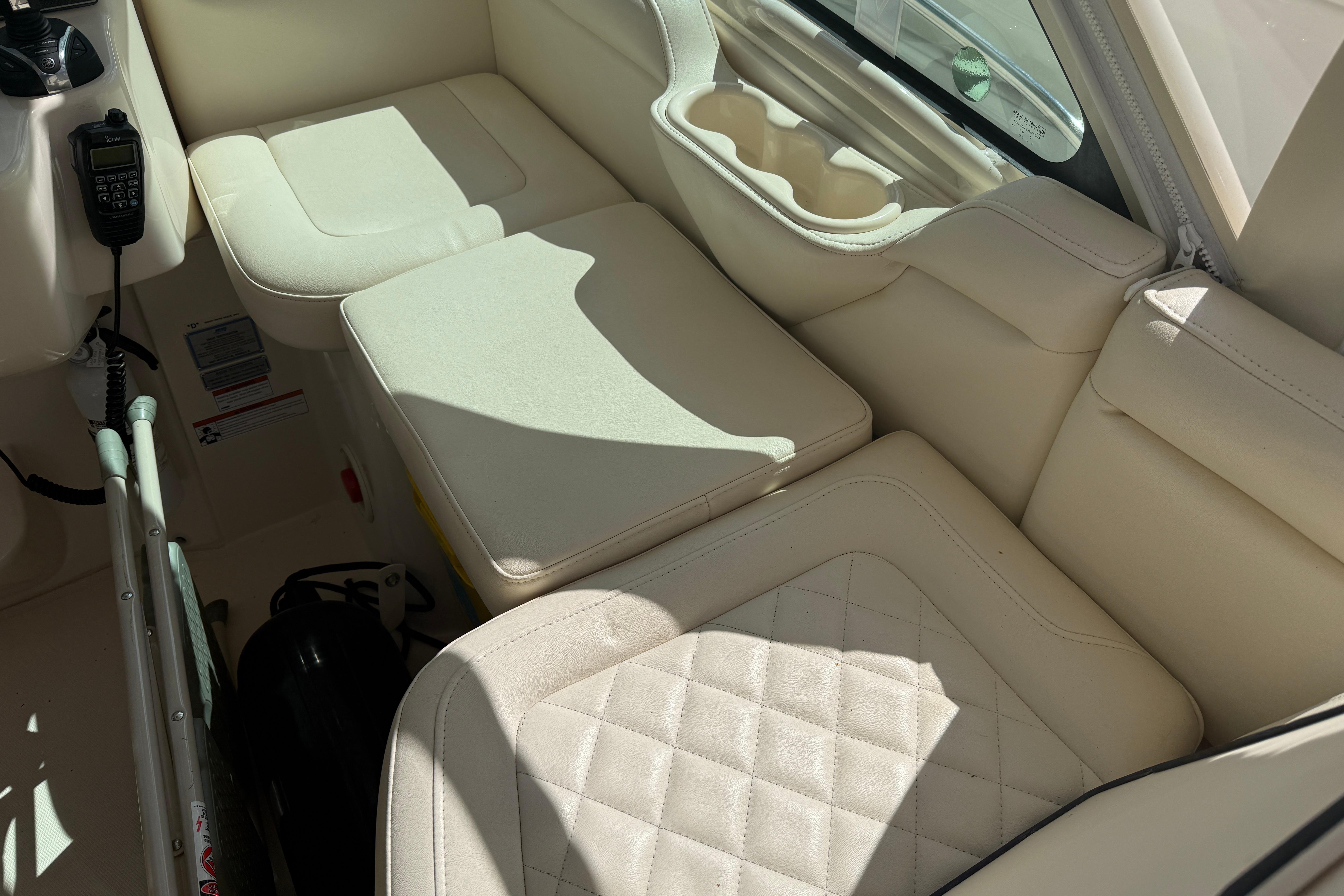 Luxurious interior seating of 2021 Grady-White Express 330 boat with beige upholstery.