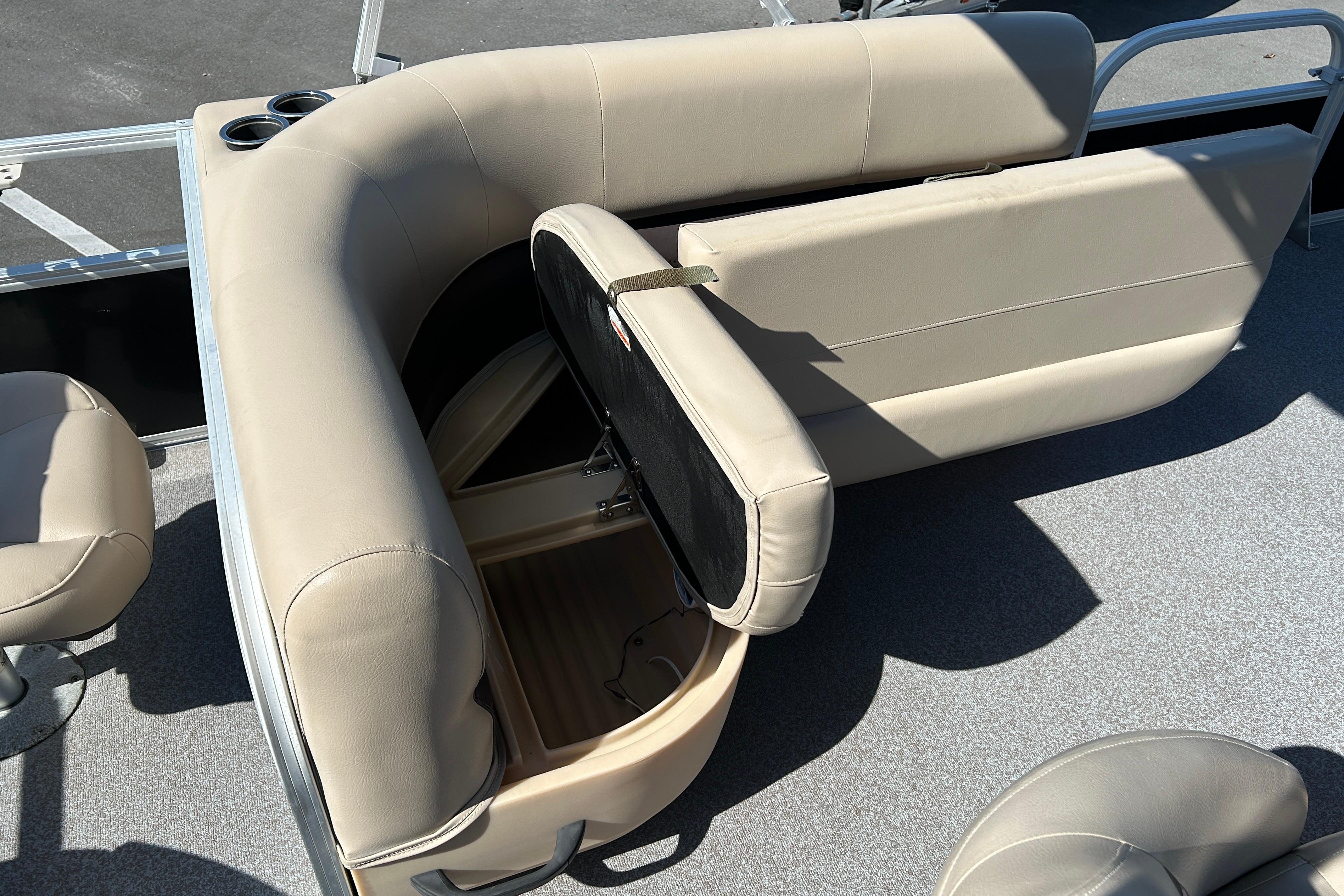 2017 Sun Tracker Bass Buggy 18 DLX boat interior with beige seating and storage compartment.
