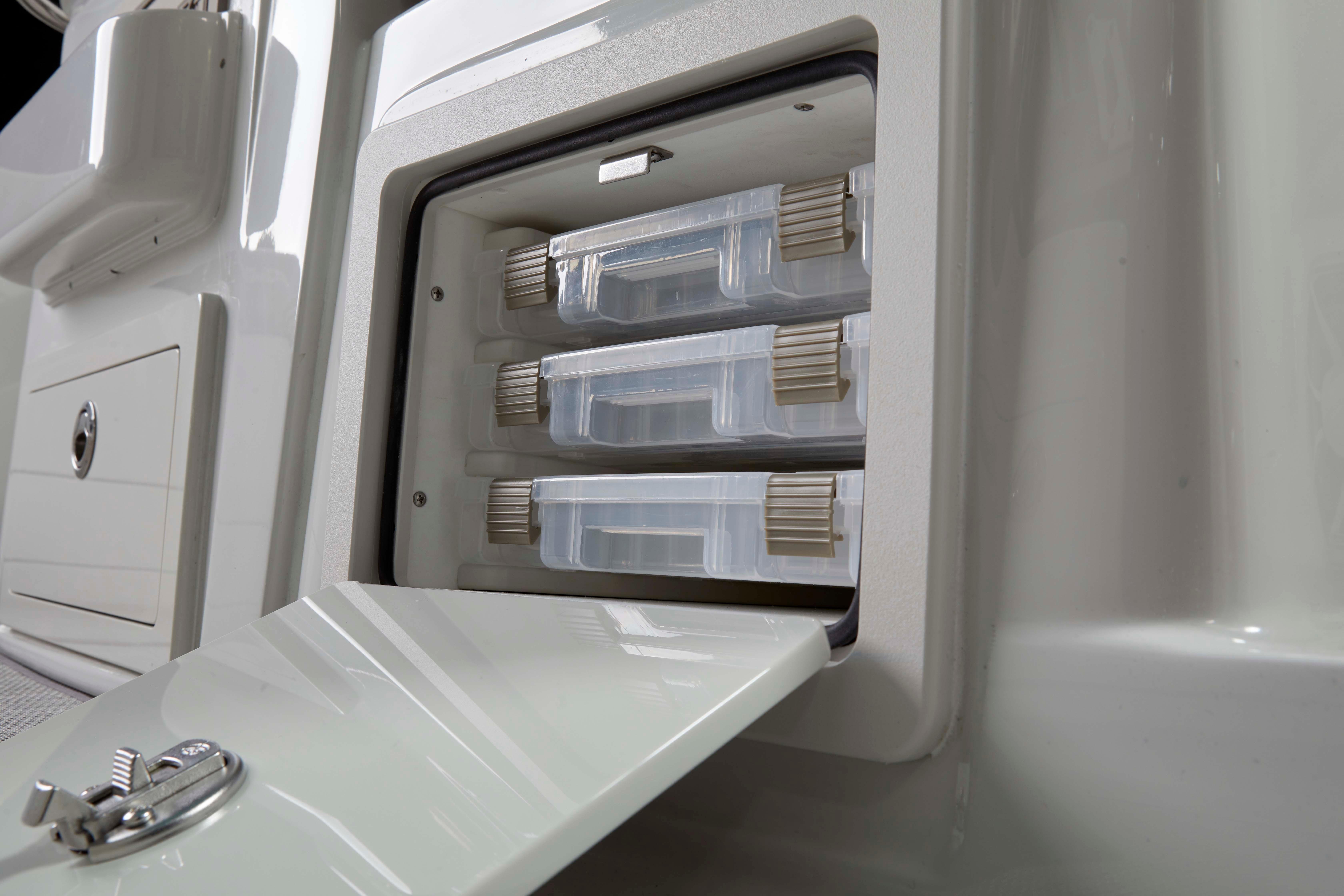 Storage compartment with tackle boxes on 2024 Finseeker 280 DC boat.