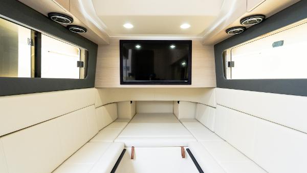 Luxurious interior of 2025 Scout 425 LXF yacht with modern seating and entertainment system.