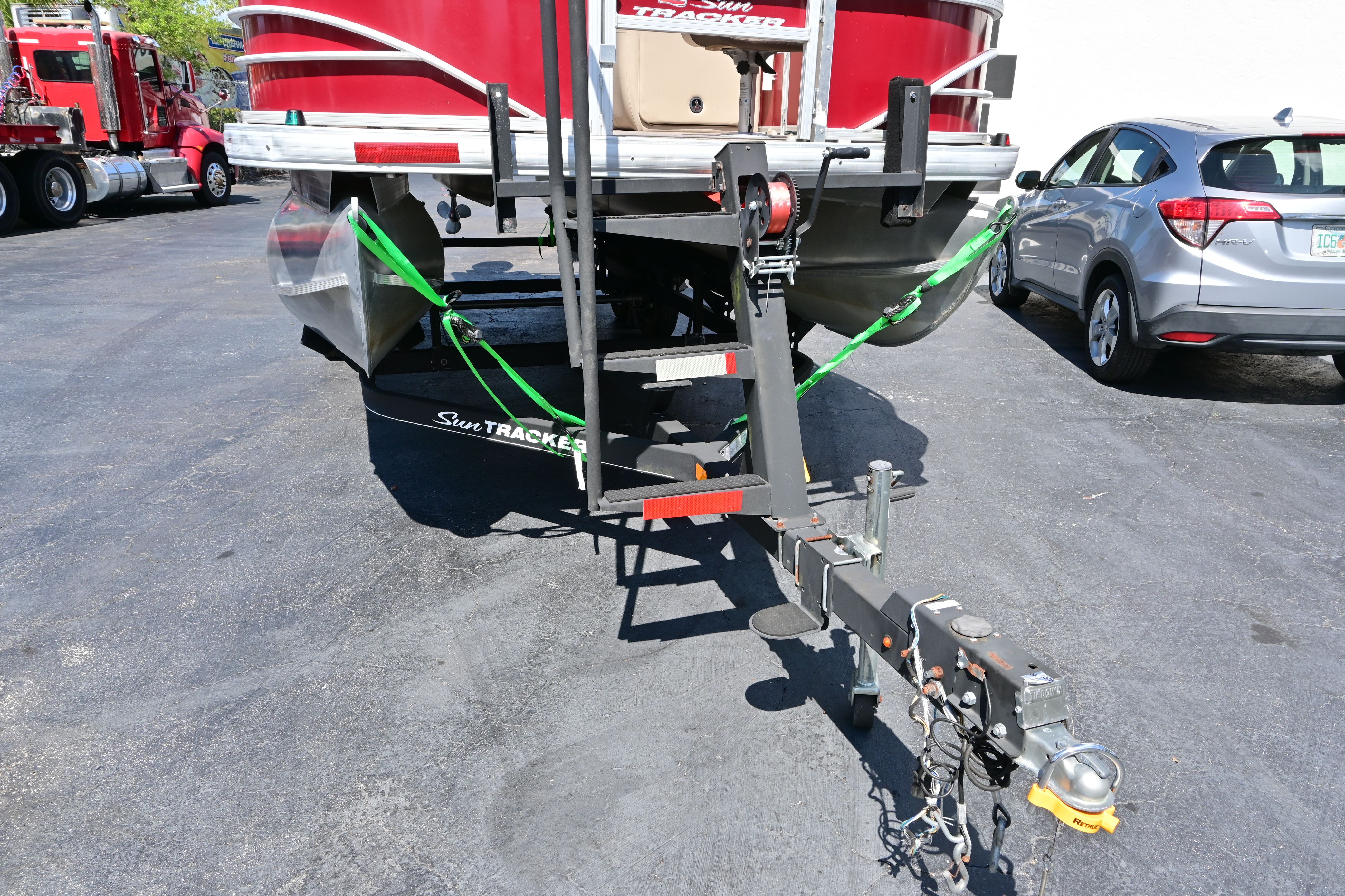 2019 Sun Tracker FISHI boat trailer in parking lot.