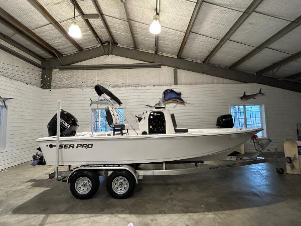 2025 Sea Pro 210 Bay boat on trailer in a garage setting.