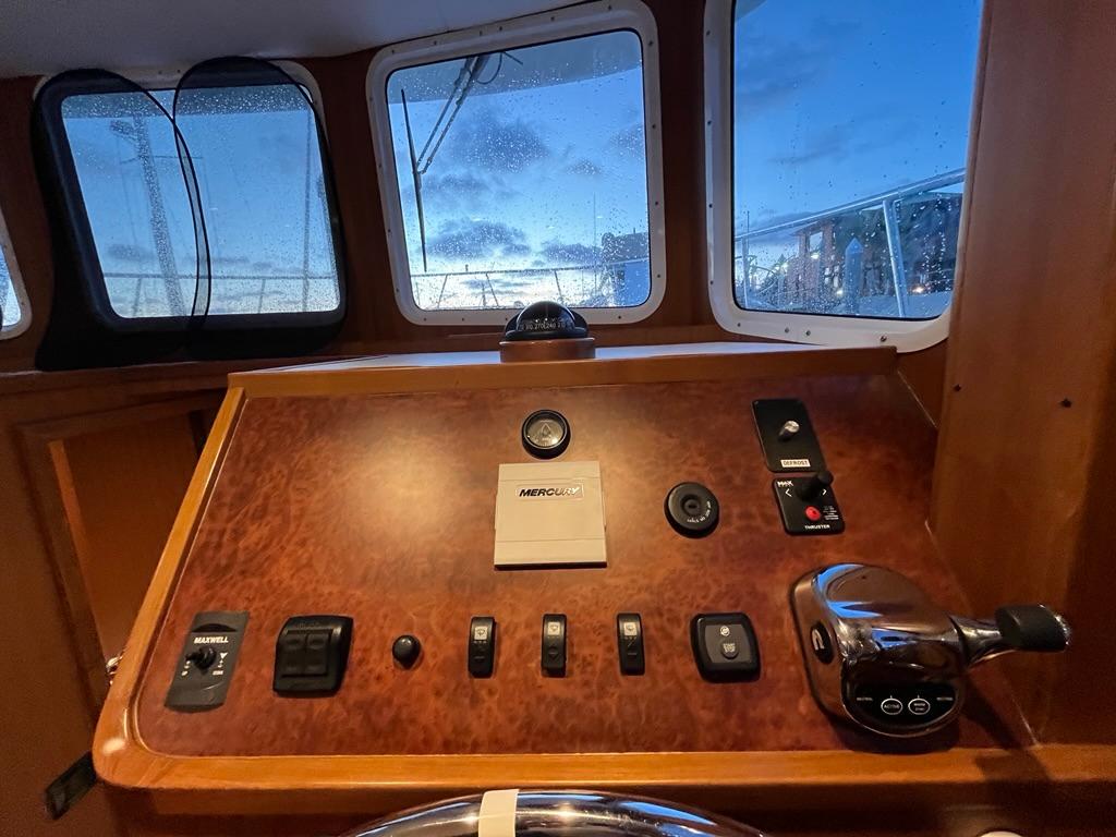 Bracewell 41 yacht helm, 2025 model, featuring control panel and windows with evening view.