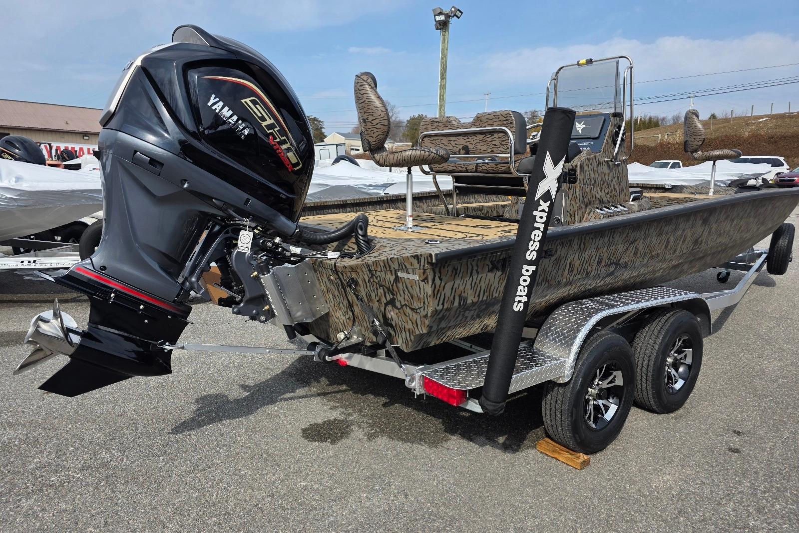 2026 Xpress H22B Bay boat with Yamaha motor on trailer, camo design.
