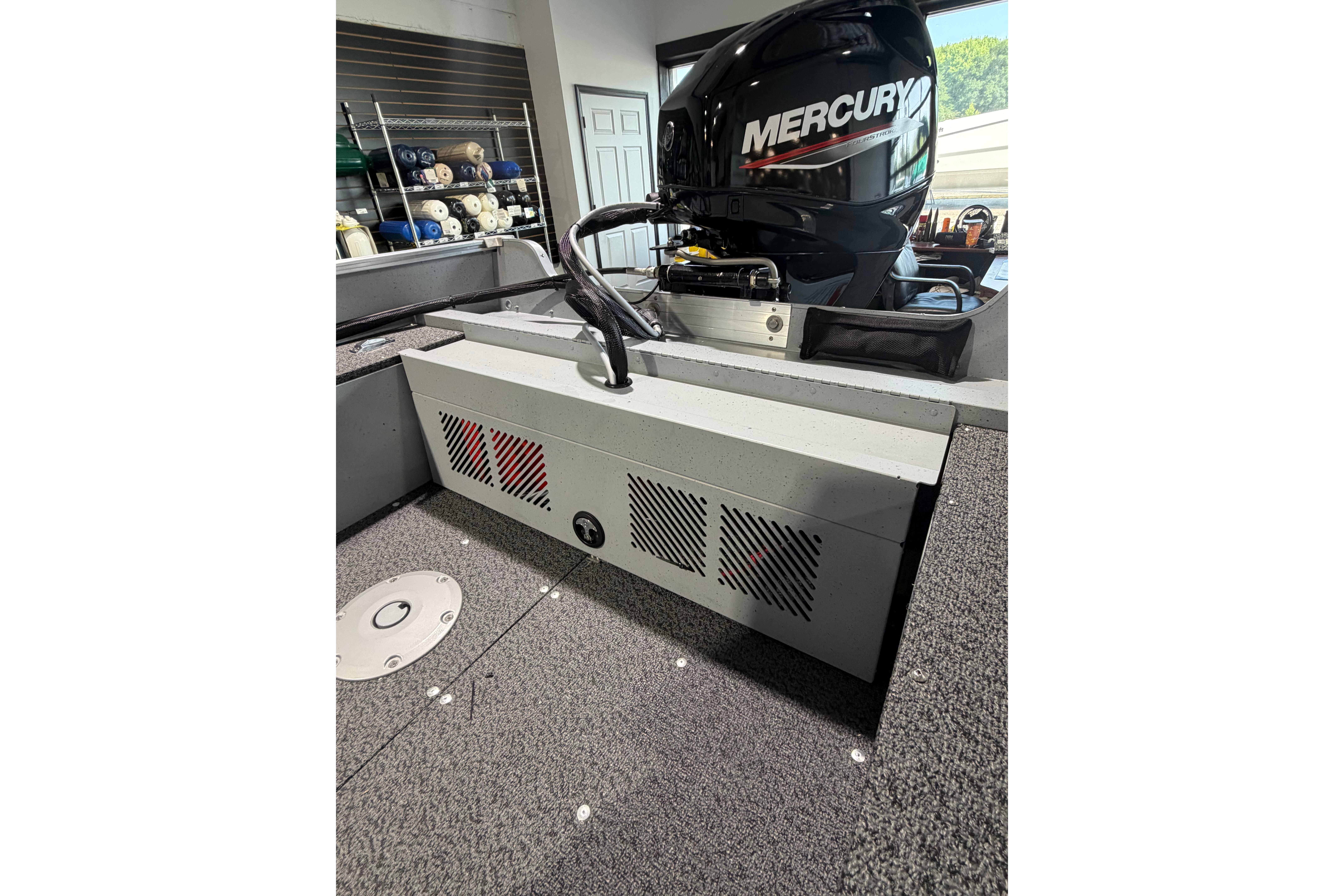 2027 Lund 1600 Fury SS boat interior with Mercury engine, showcasing storage and seating.
