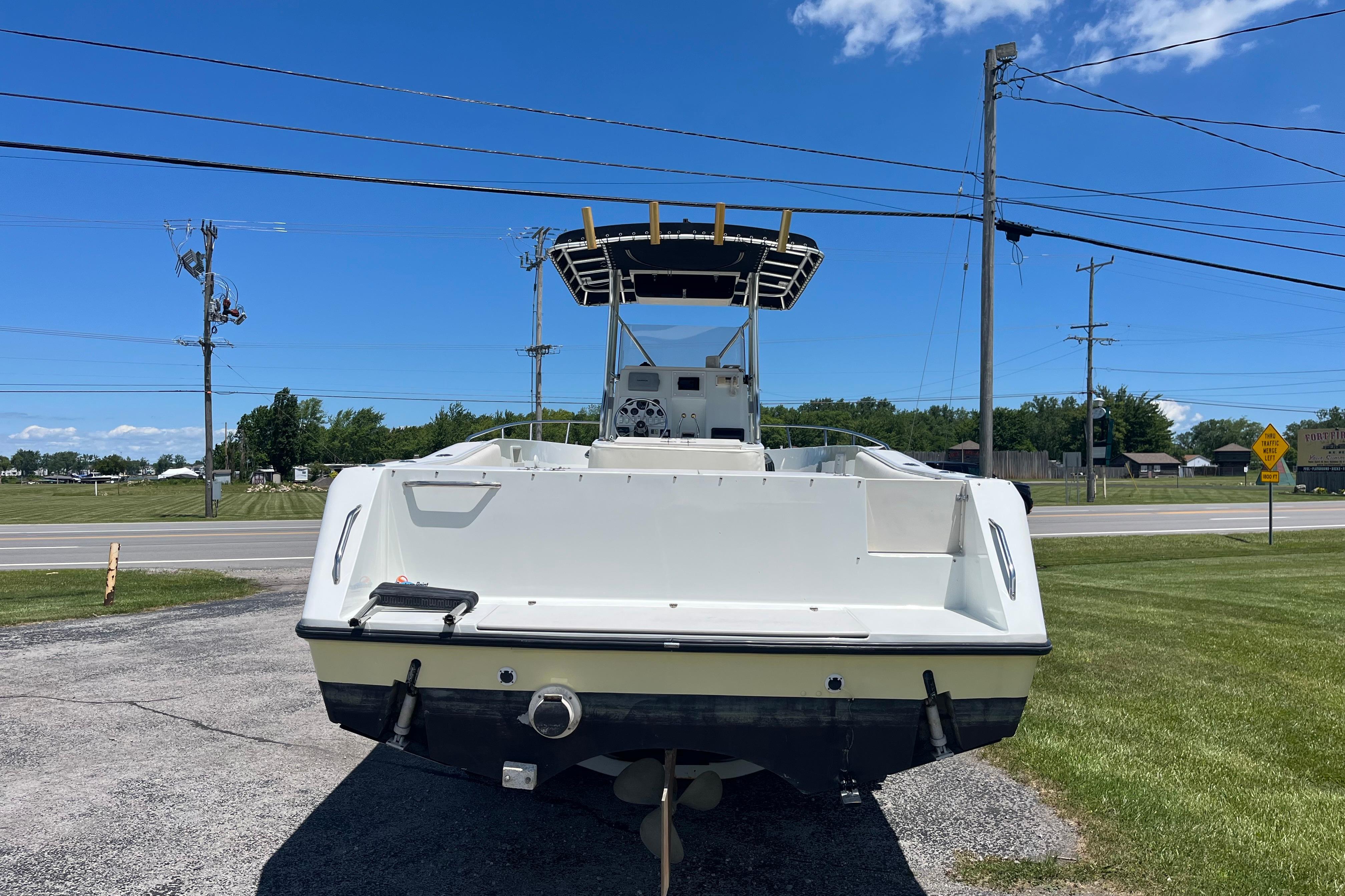 1997 Stamas boat on display outdoors, clear sky background.