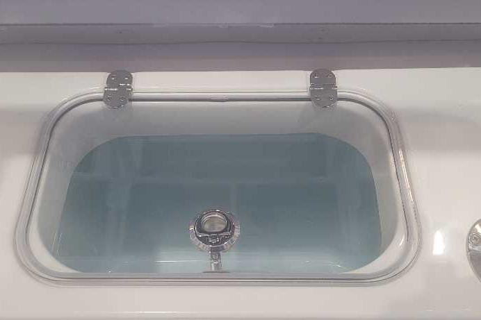 Livewell on 2026 Mako 214 Center Console boat, featuring a clear lid and secure latch.