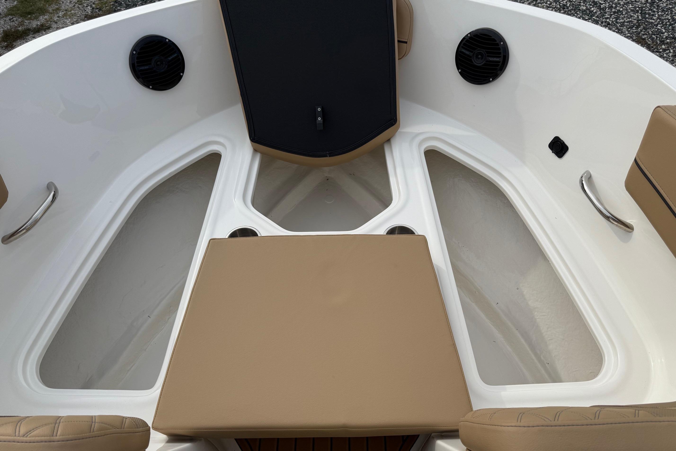 2026 Bayliner VR6 Bowrider OB interior with tan seating and storage compartments.