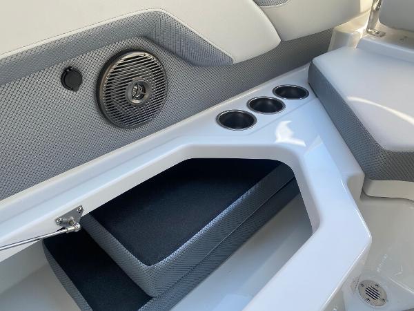 2025 Scarab 235 SE boat interior with speaker, cup holders, and seating.