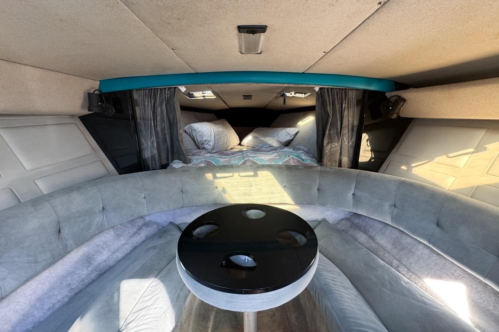 Interior of a 1989 Formula 292 SR-1 boat with cozy seating and a small table.