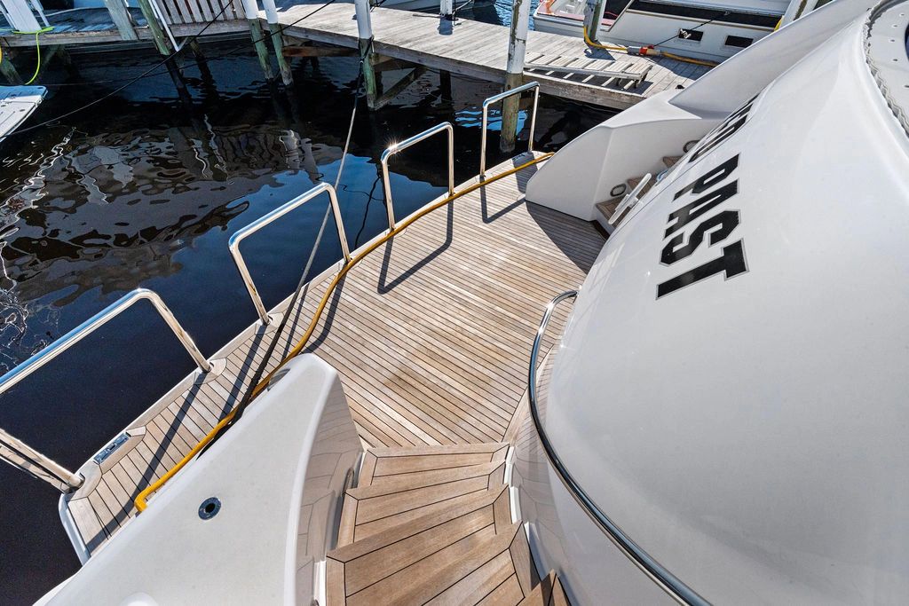 1999 Westport 112 yacht with wooden deck at dock.