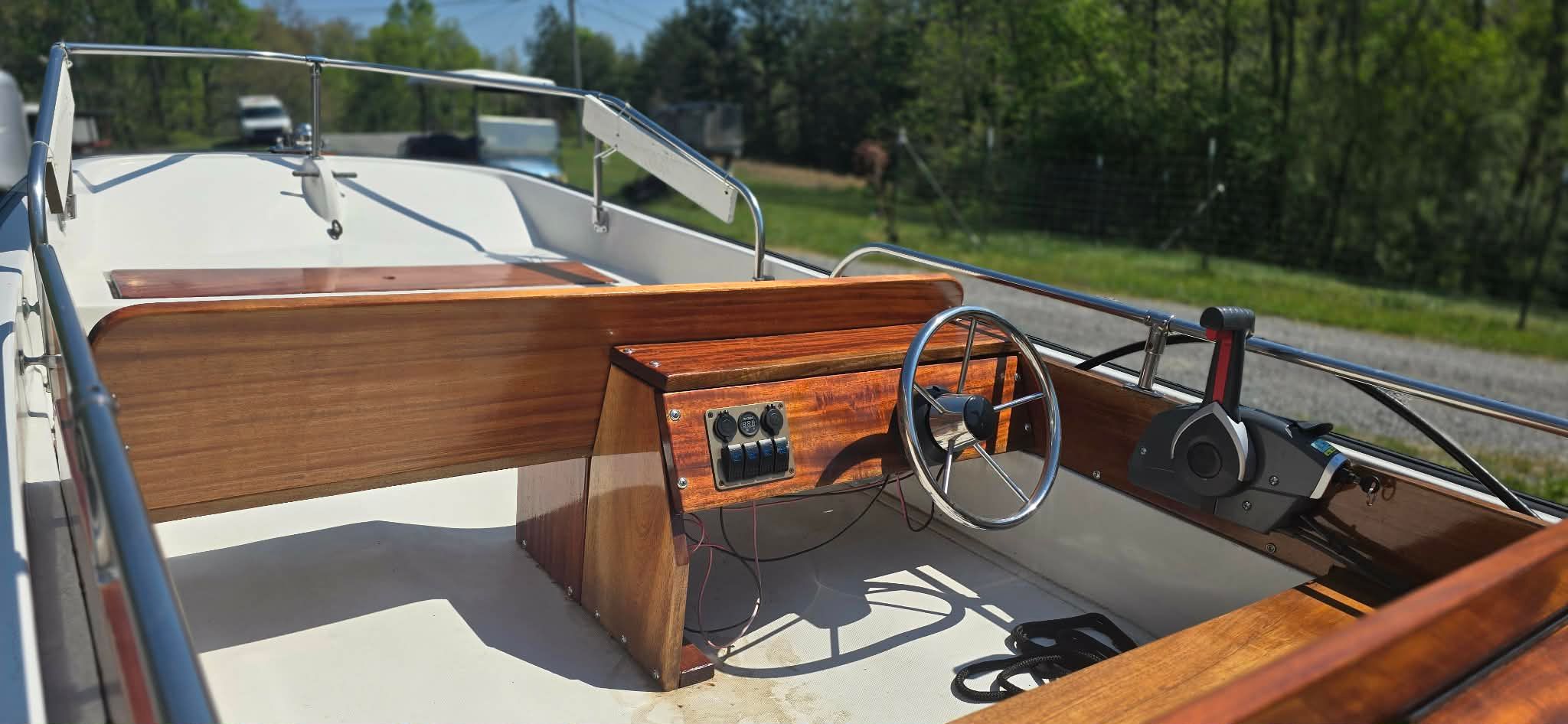 Interior view of a 1977 Boston Whaler 13 boat with wooden trim.